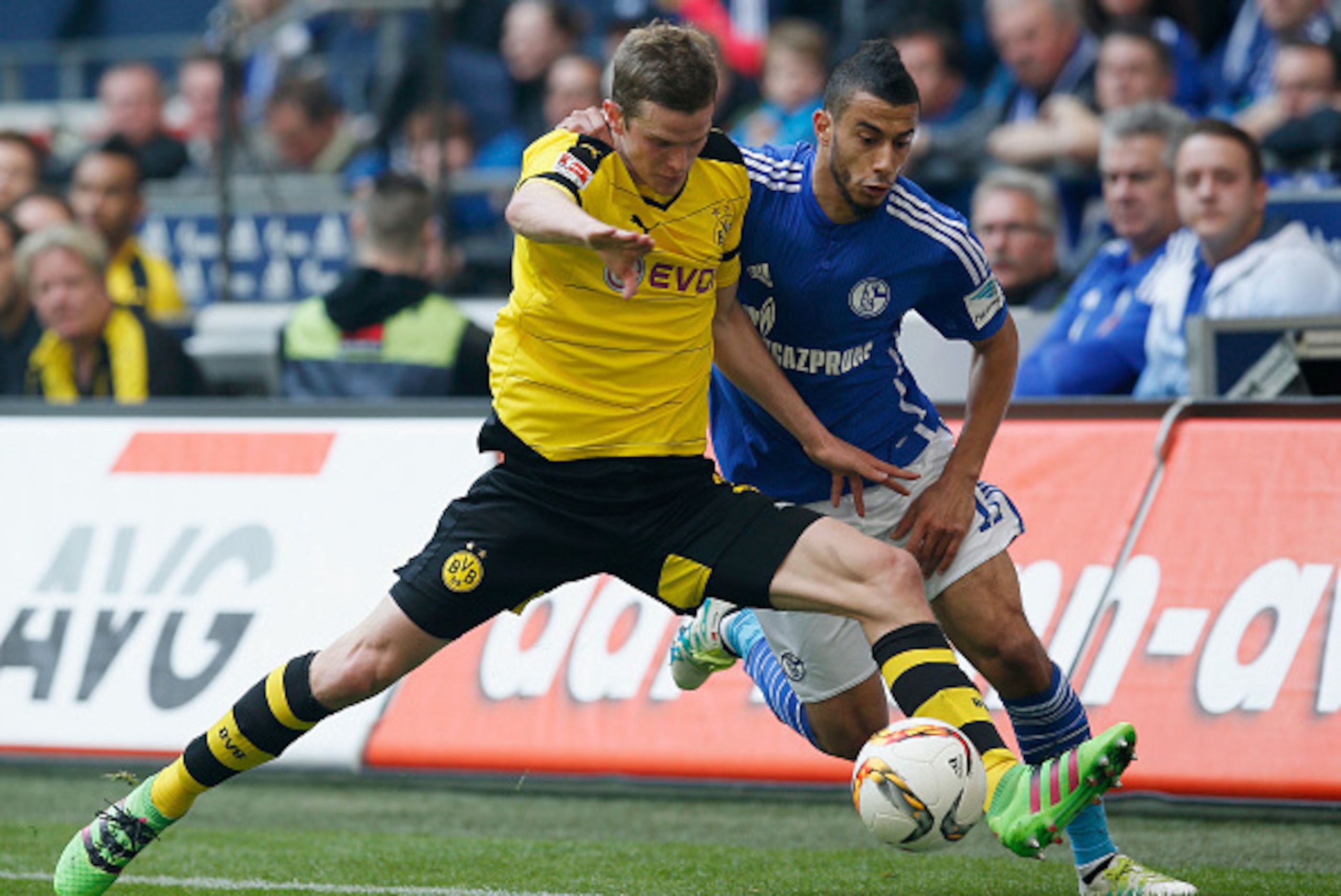 GELSENKIRCHEN, NORTH RHINE-WESTPHALIA - APRIL 10:  Younes Belhanda (R) of FC Schalke 04 is challenged by Sven Bender (L) of Borussia Dortmund during the Bundesliga match between FC Schalke 04 and Borussia Dortmund at Veltins-Arena on April 10, 2016 in Gel