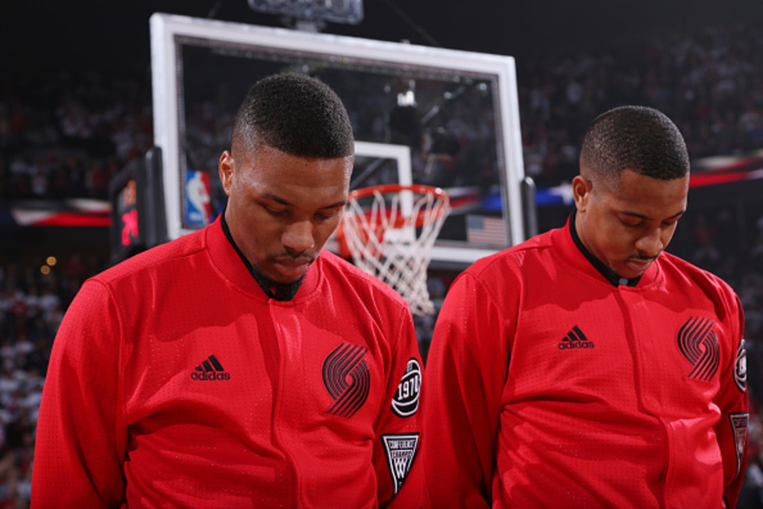 PORTLAND, OR - APRIL 29:  Damian Lillard #0 and C.J. McCollum #3 of the Portland Trail Blazers stand for the national anthem before the game against the Los Angeles Clippers in Game Six of the Western Conference Quarterfinals during the 2016 NBA Playoffs 