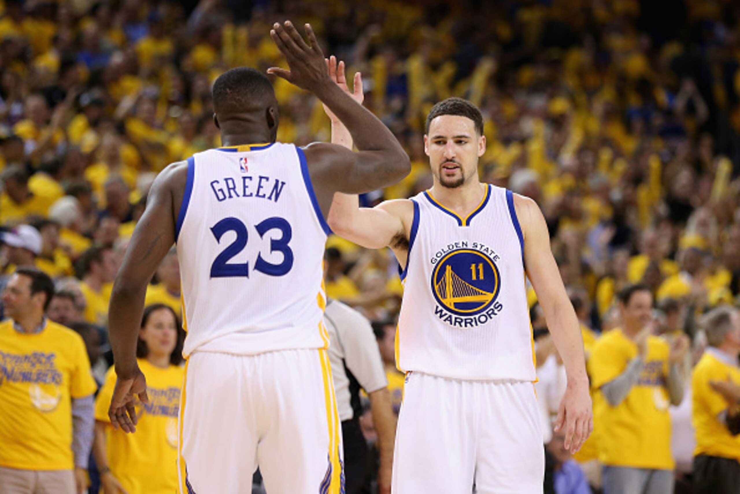 OAKLAND, CA - MAY 03:  Klay Thompson #11 and Draymond Green #23 of the Golden State Warriors celebrate in the final minute of their victory over the Portland Trail Blazers in Game Two of the Western Conference Semifinals during the 2016 NBA Playoffs on Ma