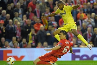 Villarreal's Congolese forward Cedric Bakambu (Top) is challenged by Liverpool's Croatian defender Dejan Lovren during the UEFA Europa League semi-final second leg football match between Liverpool and Villarreal CF at Anfield in Liverpool, northwest Engla