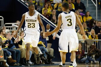 ANN ARBOR, MI - JANUARY 06: Caris LeVert #23 of the Michigan Wolverines slap hands with teammate Trey Burke as he subs in while playing the Iowa Hawkeyes at Crisler Center on January 6, 2012 in Ann Arbor, Michigan. (Photo by Gregory Shamus/Getty Images)