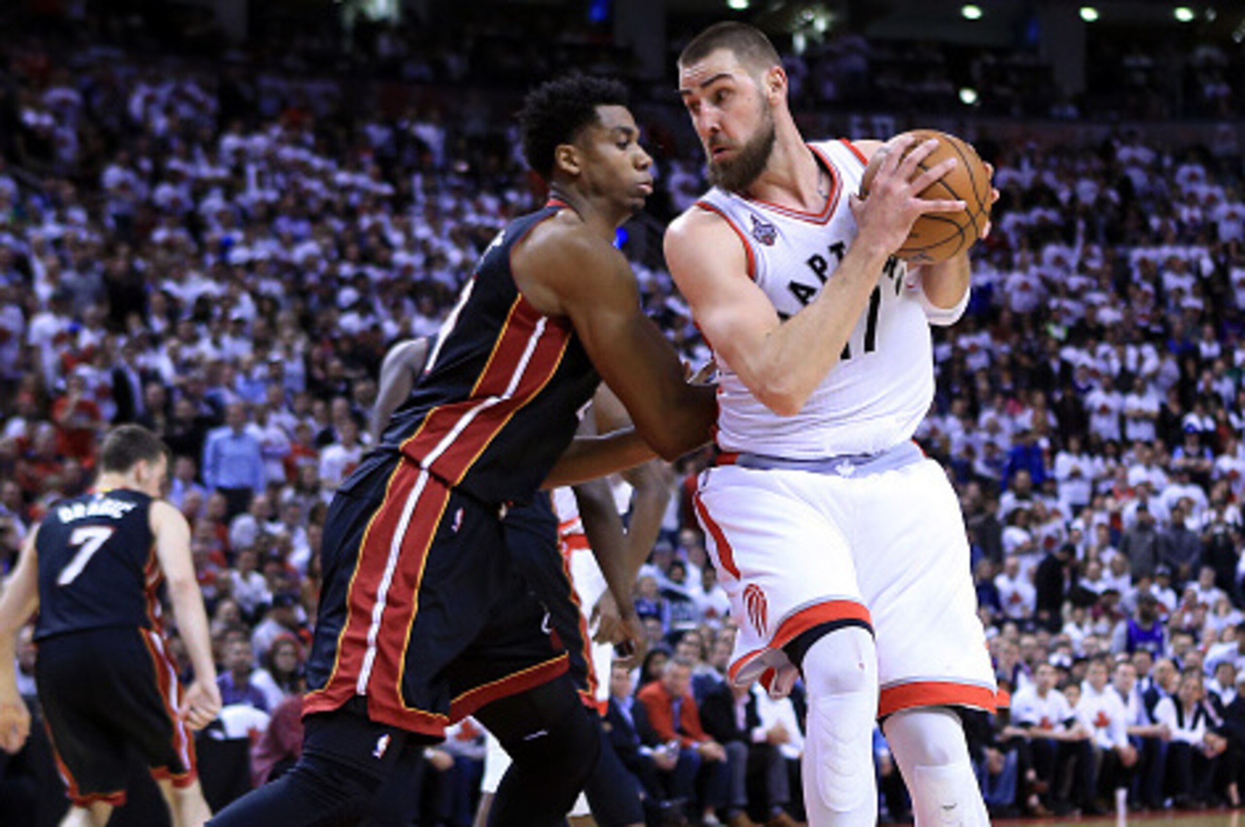 TORONTO, ON - MAY 03:  Jonas Valanciunas #17 of the Toronto Raptors drives to the basket as Hassan Whiteside #21 of the Miami Heat defends in the second half of Game One of the Eastern Conference Semifinals during the 2016 NBA Playoffs at the Air Canada C