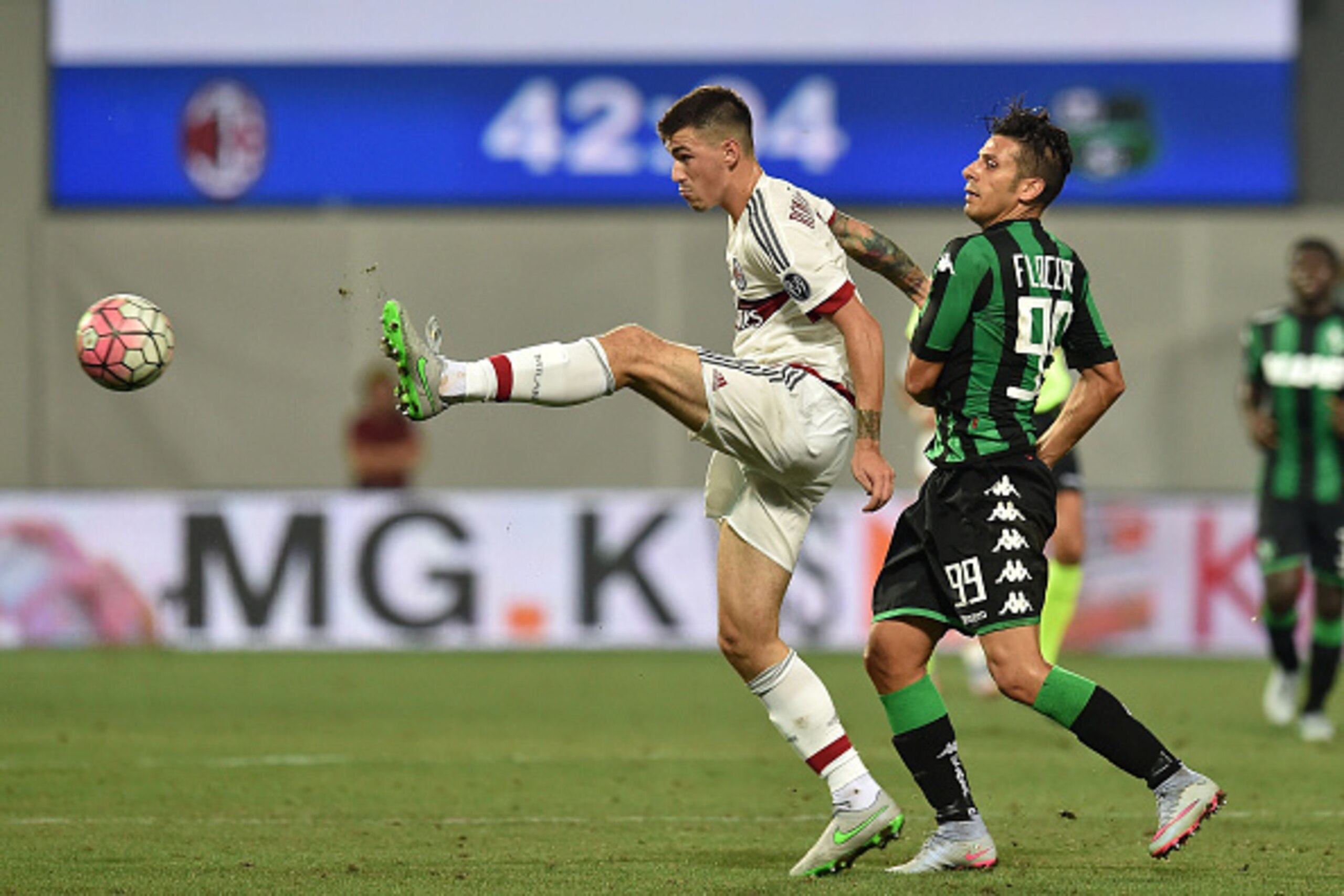 REGGIO NELL'EMILIA, ITALY - AUGUST 12:  Alessio Romagnoli of Milan and Sergio Floccari of Sassuolo in action during the TIM pre-season tournament match between AC Milan and US Sassuolo Calcio at Mapei Stadium - Città del Tricolore on August 12, 2015 in Re