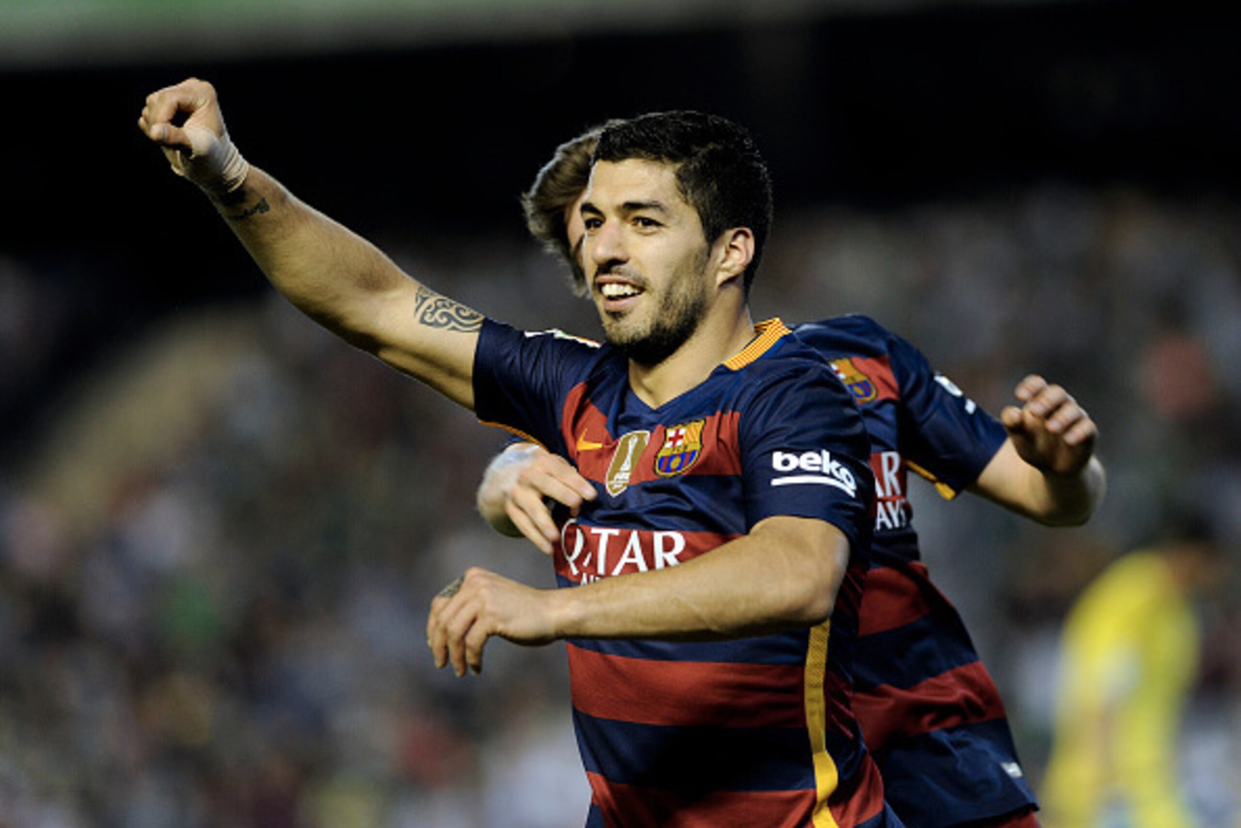 Barcelona's Uruguayan forward Luis Suarez celebrates after scoring a goal during the Spanish league football match Real Betis Balompie vs FC Barcelona at the Benito Villamarin stadium in Sevilla on April 30, 2016. / AFP / CRISTINA QUICLER        (Photo cr