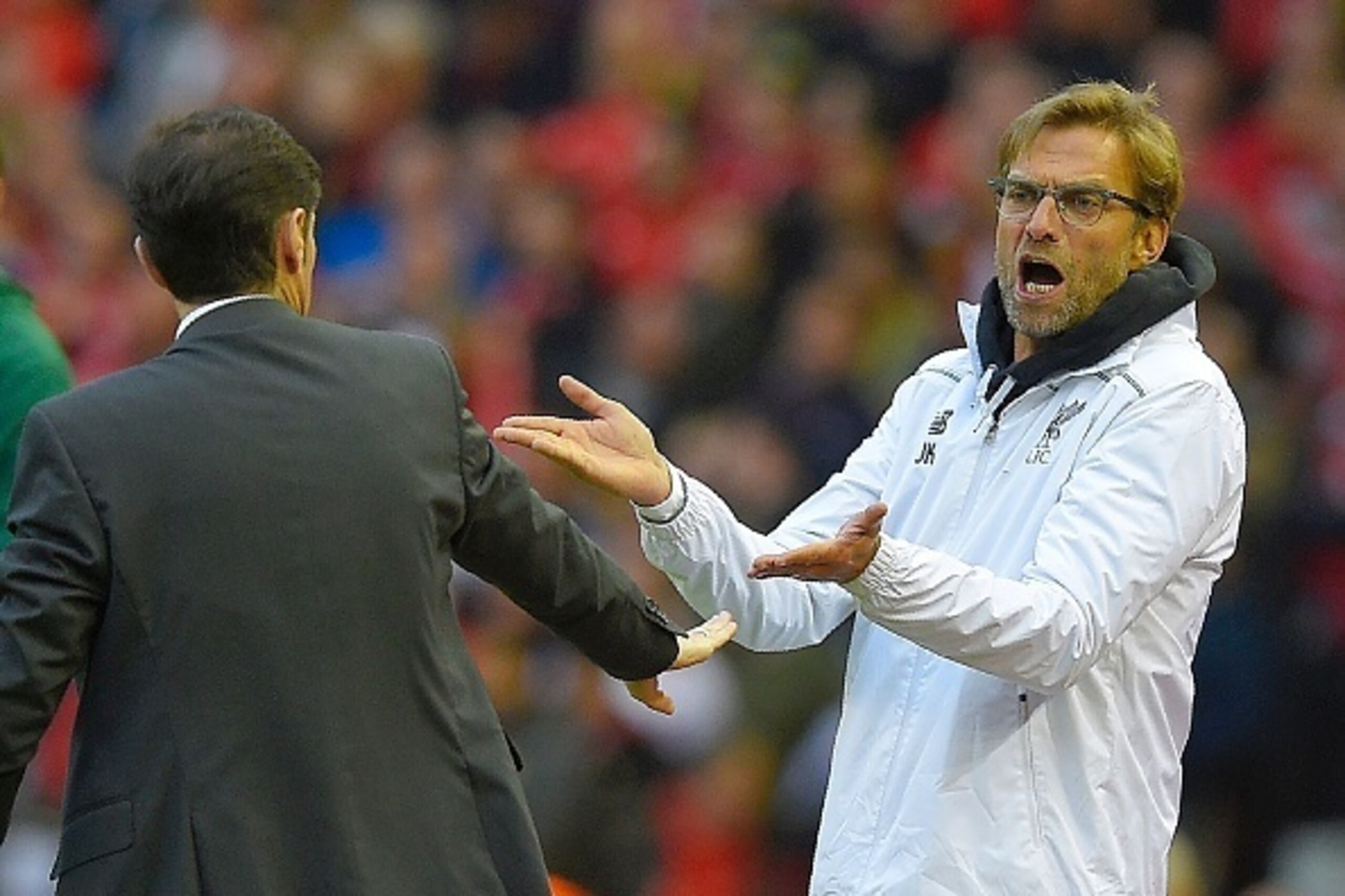 Liverpool's German manager Jurgen Klopp (L) gestures towards Villarreal's coach Marcelino Garcia Toral during the UEFA Europa League semi-final second leg football match between Liverpool and Villarreal CF at Anfield in Liverpool, northwest England on May