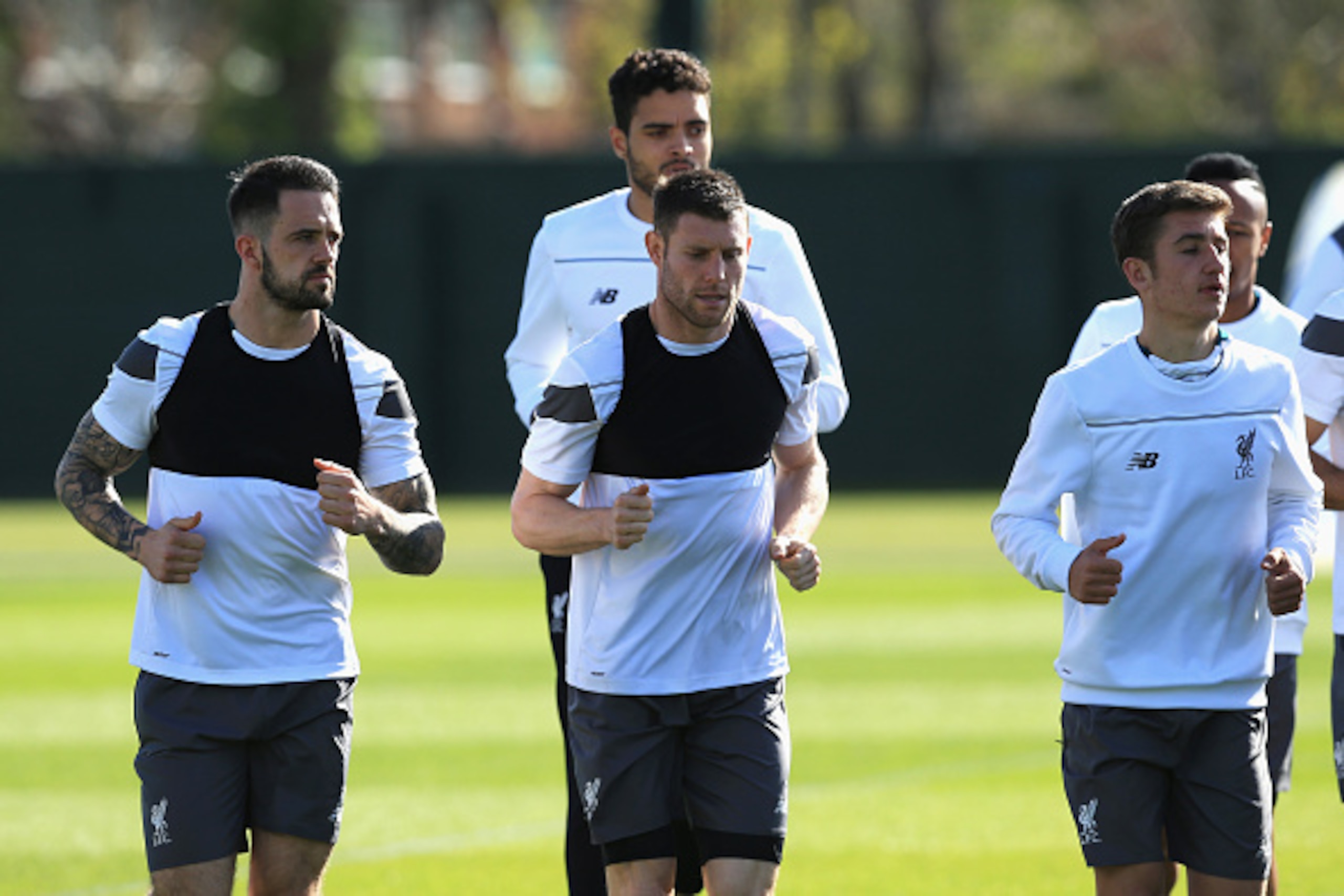 LIVERPOOL, ENGLAND - MAY 04: James Milner (C) of Liverpool warms up with Danny Ings (L) during a training session ahead of the UEFA Europa League Semi-Final Second Leg match against Villarreal at Melwood Training Ground on May 4, 2016 in Liverpool, Englan