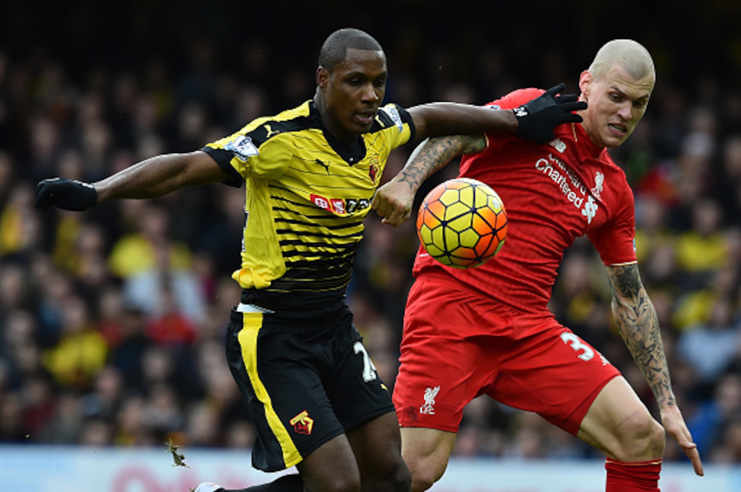 Watford's Nigerian striker Odion Ighalo (L) vies with Liverpool's Slovakian defender Martin Skrtel before scoring their second goal during the English Premier League football match between Watford and Liverpool at Vicarage Road Stadium in Watford, north o