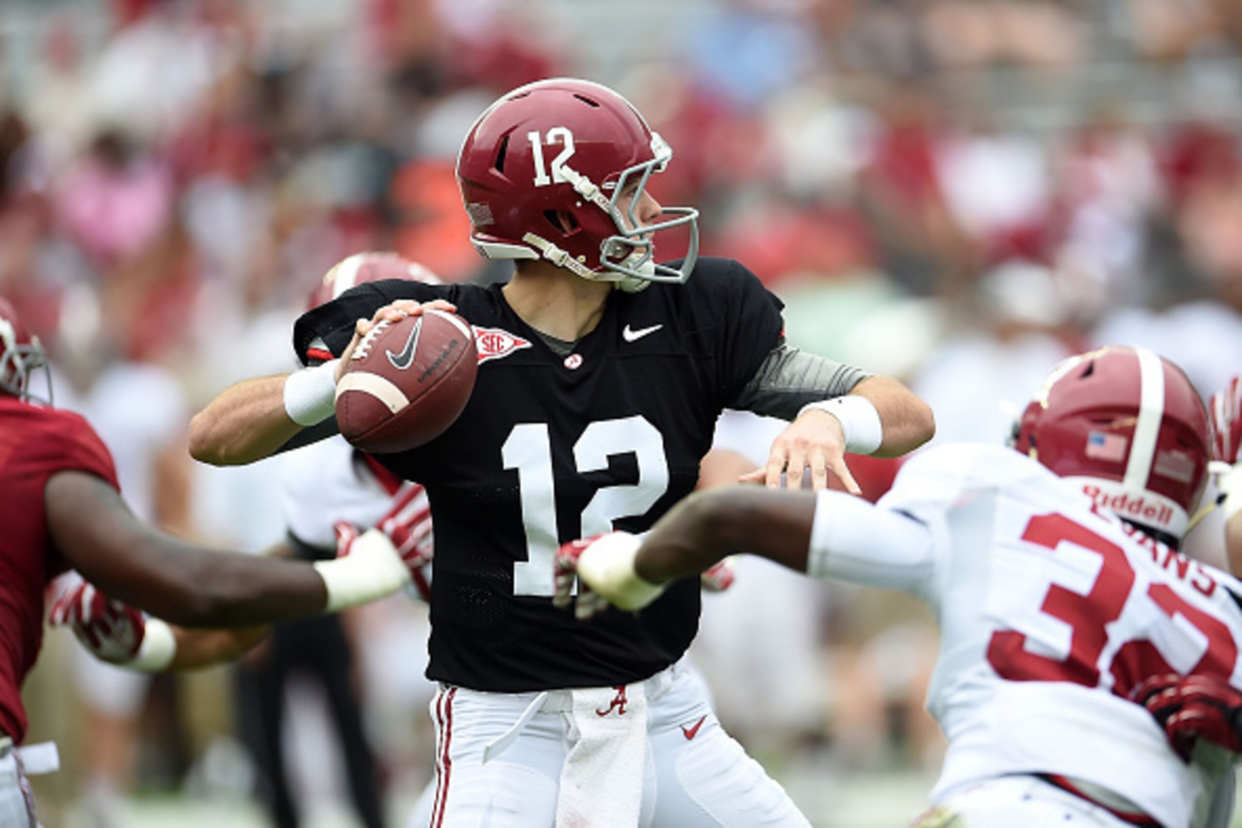 TUSCALOOSA, AL - APRIL 18:  David Cornwell #12 of the Crimson team drops back to pass against the White team during the University of Alabama A Day spring game at Bryant-Denny Stadium on April 18, 2015 in Tuscaloosa, Alabama.  (Photo by Stacy Revere/Getty