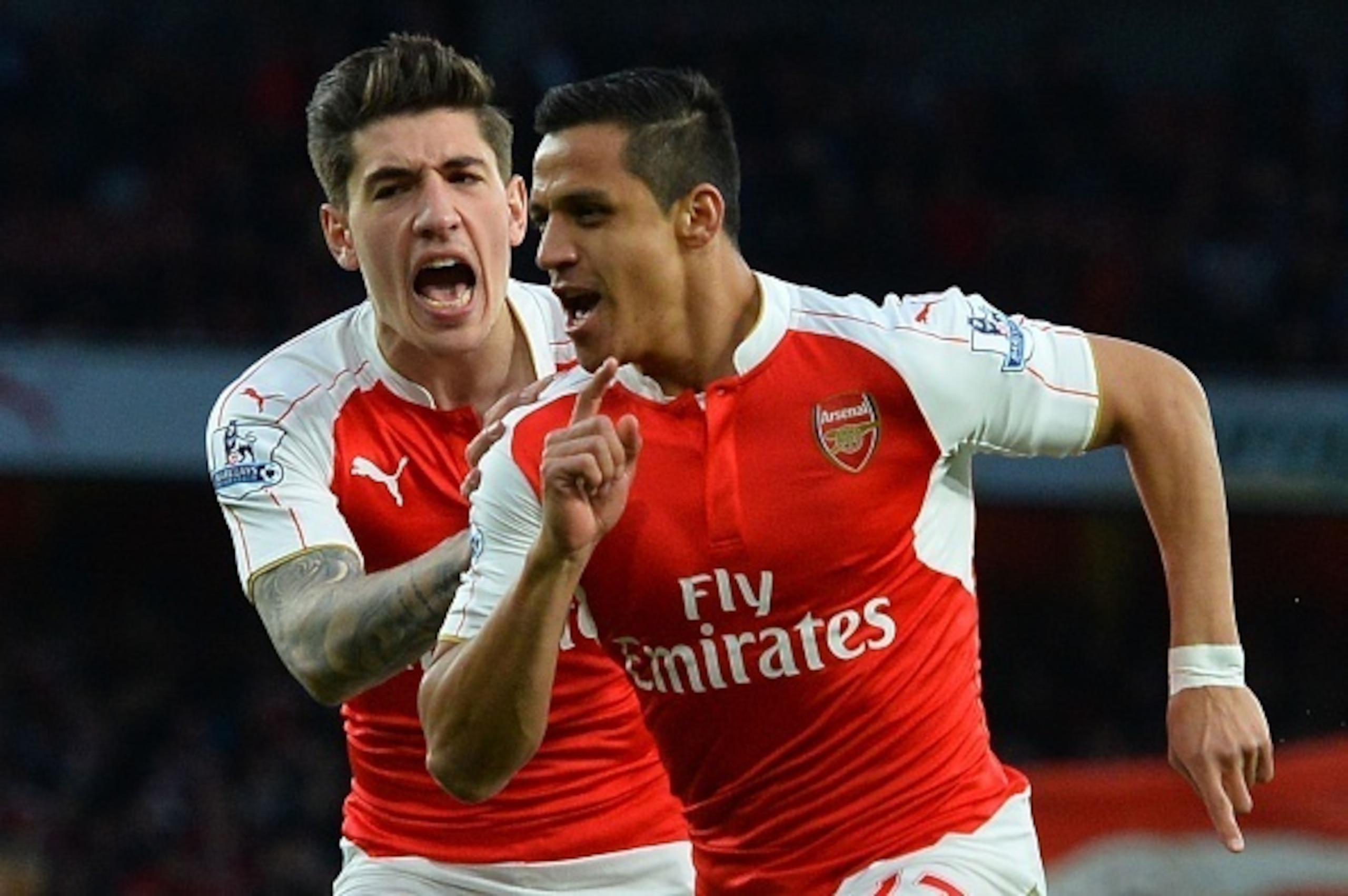 Arsenal's Chilean striker Alexis Sanchez (R) celebrates with Arsenal's Spanish defender Hector Bellerin (L) after he scored the opening goal during the English Premier League football match between Arsenal and West Bromwich Albion at the Emirates Stadium 