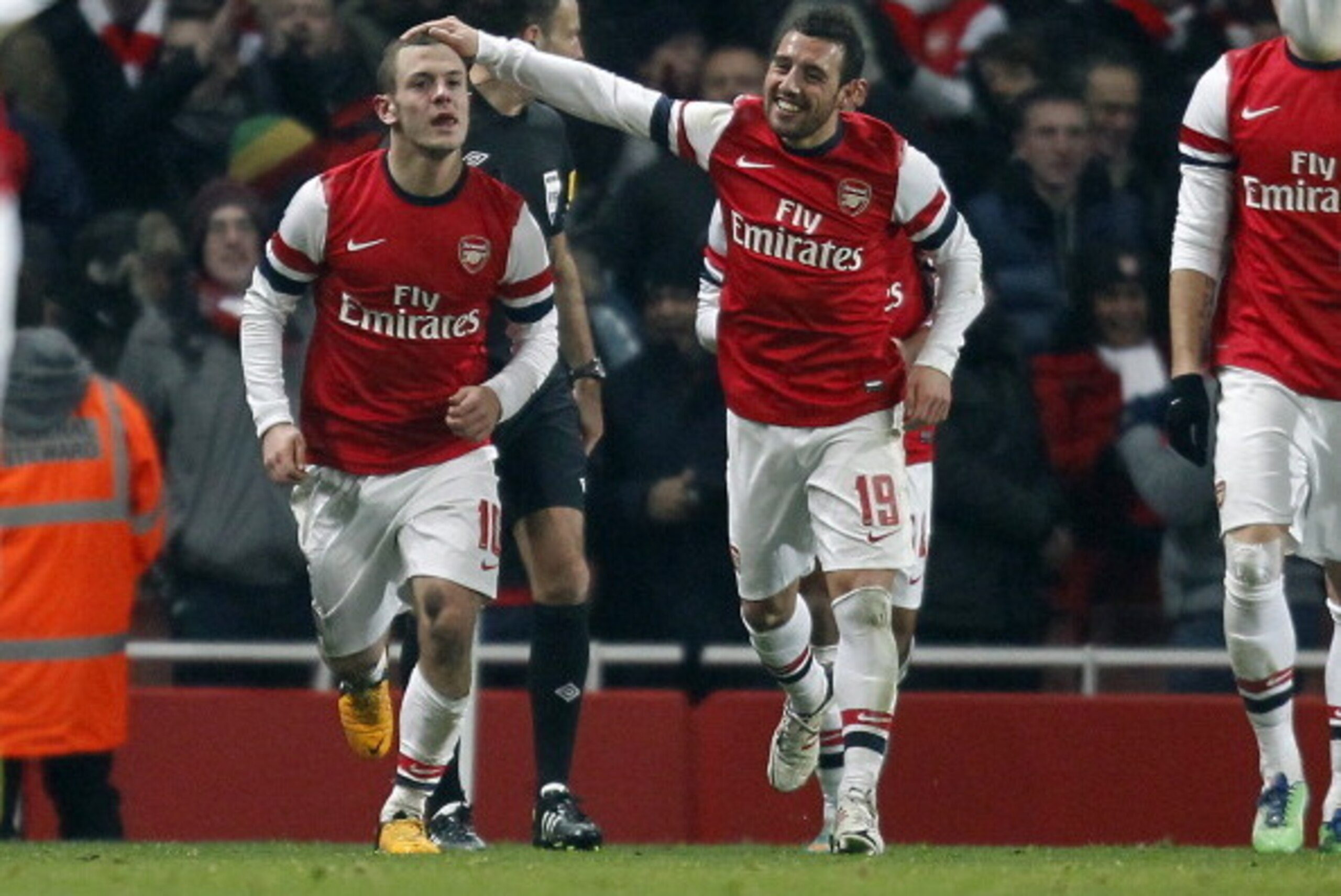 Arsenal's English midfielder Jack Wilshere (L) celebrates scoring their goal  with Arsenal's Spanish midfielder Santi Cazorla (R) during the English FA Cup third round replay football match between Arsenal and Swansea City at the Emirates Stadium in Londo