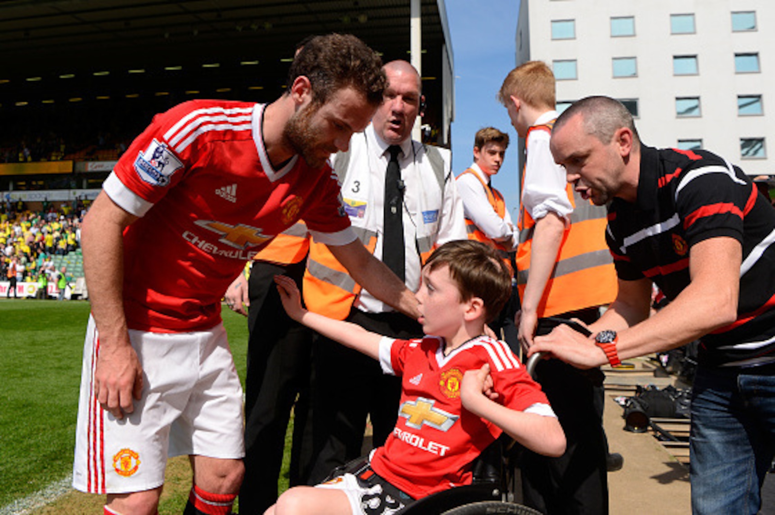 NORWICH, ENGLAND - MAY 07:  Juan Mata of Manchester United with a fan celebrate their win after the Barclays Premier League match between Norwich City and Manchester United at Carrow Road on May 7, 2016 in Norwich, England.  (Photo by Mike Hewitt/Getty Im