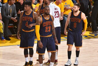 OAKLAND,CA - JUNE 7:  LeBron James #23 , Iman Shumpert #4 and Matthew Dellavedova #8 of the Cleveland Cavaliers look on against the Golden State Warriors at the Oracle Arena During Game Two of the 2015 NBA Finals on June 7, 2015 in Oakland,California NOTE
