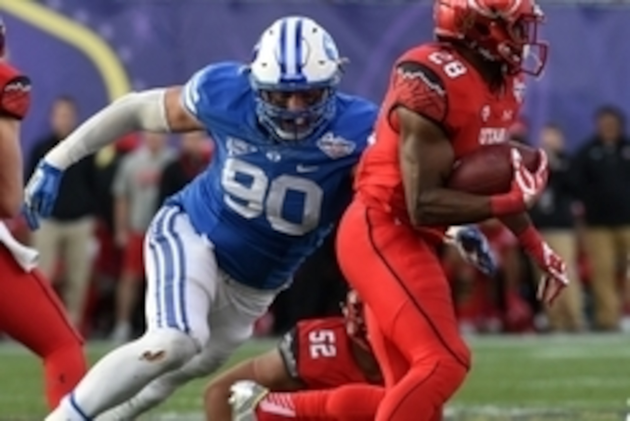Dec 19, 2015; Las Vegas, NV, USA; Brigham Young Cougars defensive lineman Bronson Kaufusi (90) tackles Utah Utes running back Joe Williams (28) in the Las Vegas Bowl at Sam Boyd Stadium. Utah defeated BYU 35-28. Mandatory Credit: Kirby Lee-USA TODAY Sport Dec 19, 2015; Las Vegas, NV, USA; Brigham Young Cougars defensive lineman Bronson Kaufusi (90) tackles Utah Utes running back Joe Williams (28) in the Las Vegas Bowl at Sam Boyd Stadium. Utah defeated BYU 35-28. Mandatory Credit: Kirby Lee-USA TODAY Sport