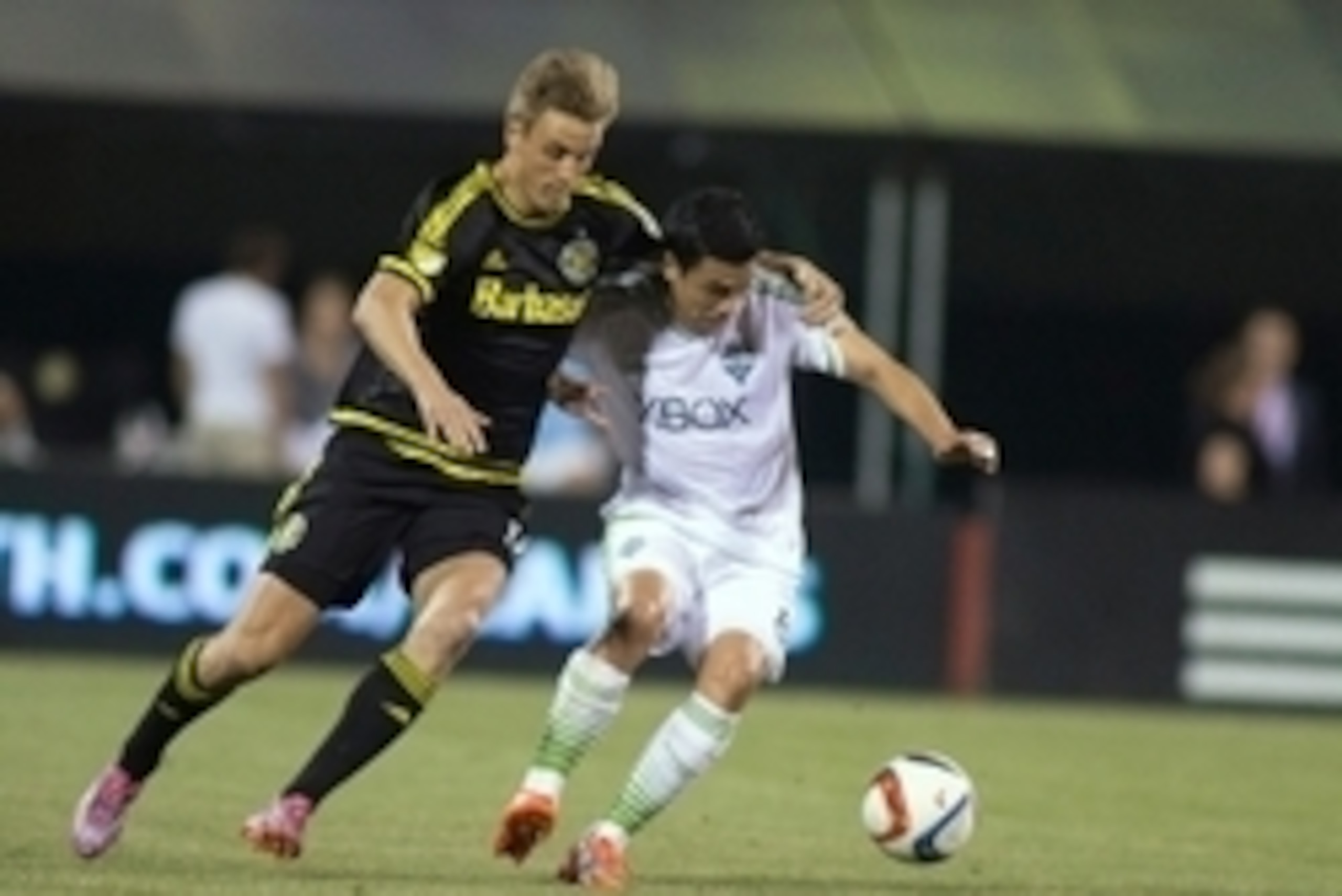 May 9, 2015; Columbus, OH, USA; Seattle Sounders FC midfielder Gonzalo Pineda (8) is fouled by Columbus Crew SC forward Aaron Schoenfeld (18) in the second half of the game at MAPFRE Stadium. The Columbus Crew SC beat the Seattle Sounders FC 3-2. Mandator