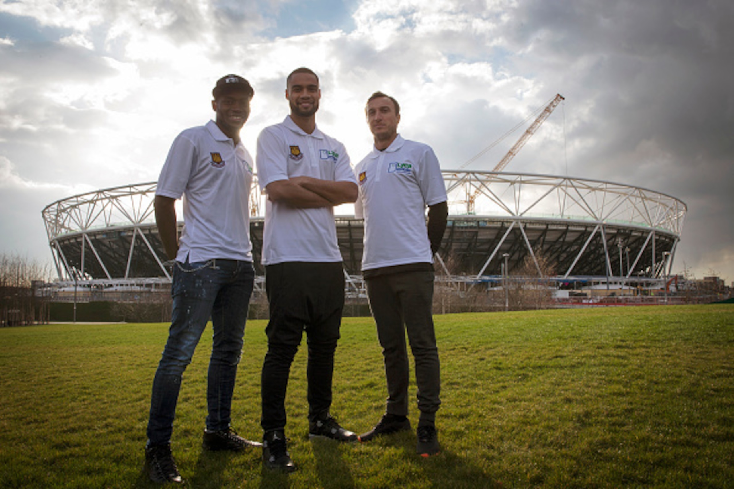 LONDON, ENGLAND - MARCH 24:  West Ham United players  Diafra Sakho, Winston Reid and Mark Noble poses for photographers outside the olympic stadium during a Lycamobile & West Ham United Partnership Announcement on March 24, 2015 in London, England.  (Phot