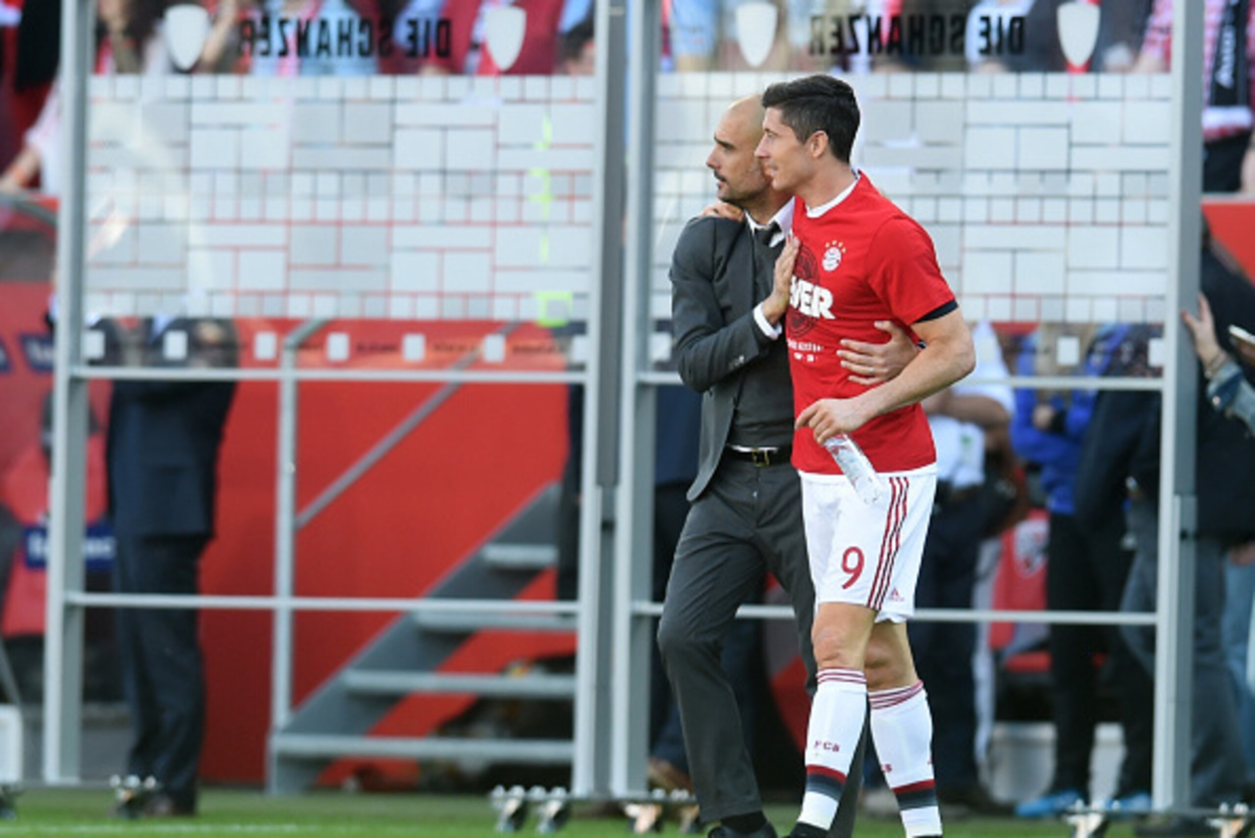 Bayern Munich's Spanish headcoach Pep Guardiola (L) embraces Bayern Munich's Polish striker Robert Lewandowski as they celebrate wining the league for the fourth year in a row after the German first division Bundesliga football match between FC Ingolstadt