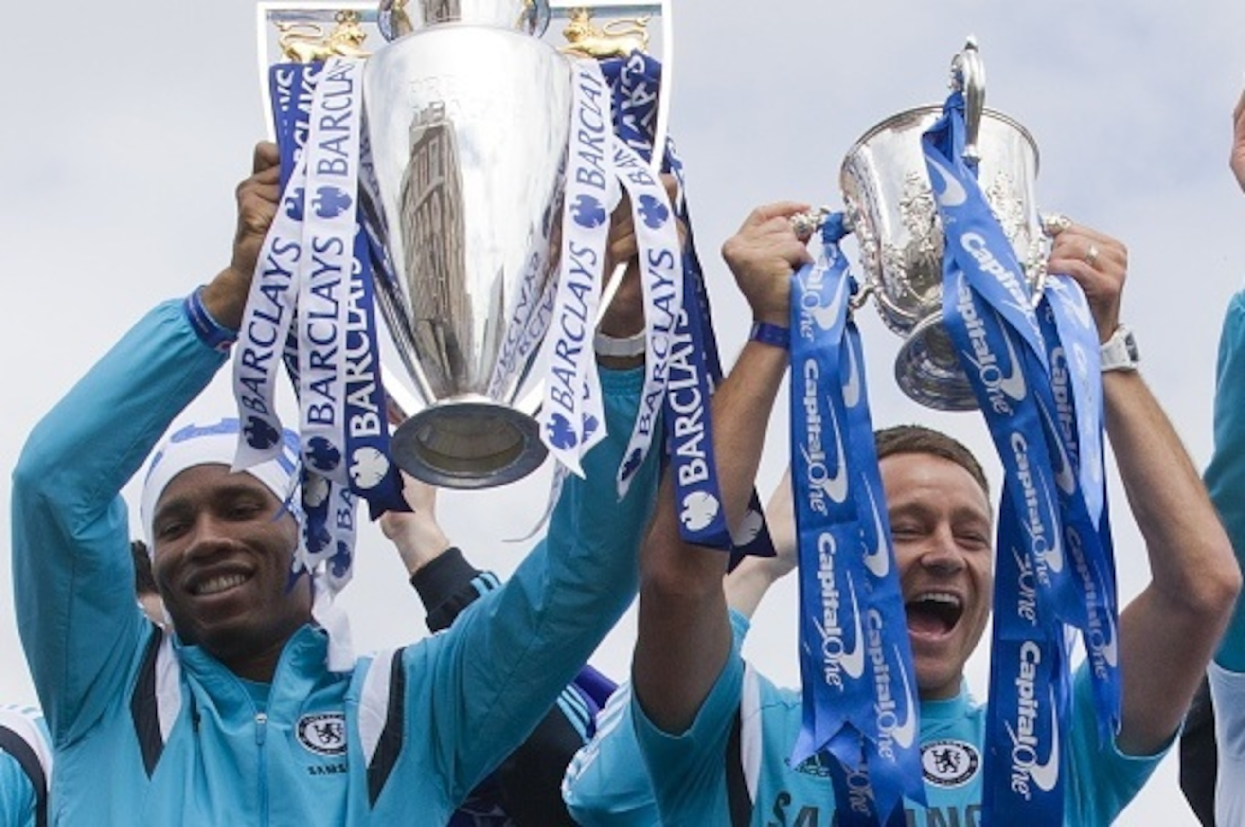 Chelsea's Ivorian striker Didier Drogba (L) holds up the Premier league trophy as Chelsea's English defender John Terry holds up the League cup as they leave Stamford Bridge stadium to take part in an open-top bus parade to celebrate winning the league in Chelsea's Ivorian striker Didier Drogba (L) holds up the Premier league trophy as Chelsea's English defender John Terry holds up the League cup as they leave Stamford Bridge stadium to take part in an open-top bus parade to celebrate winning the league in