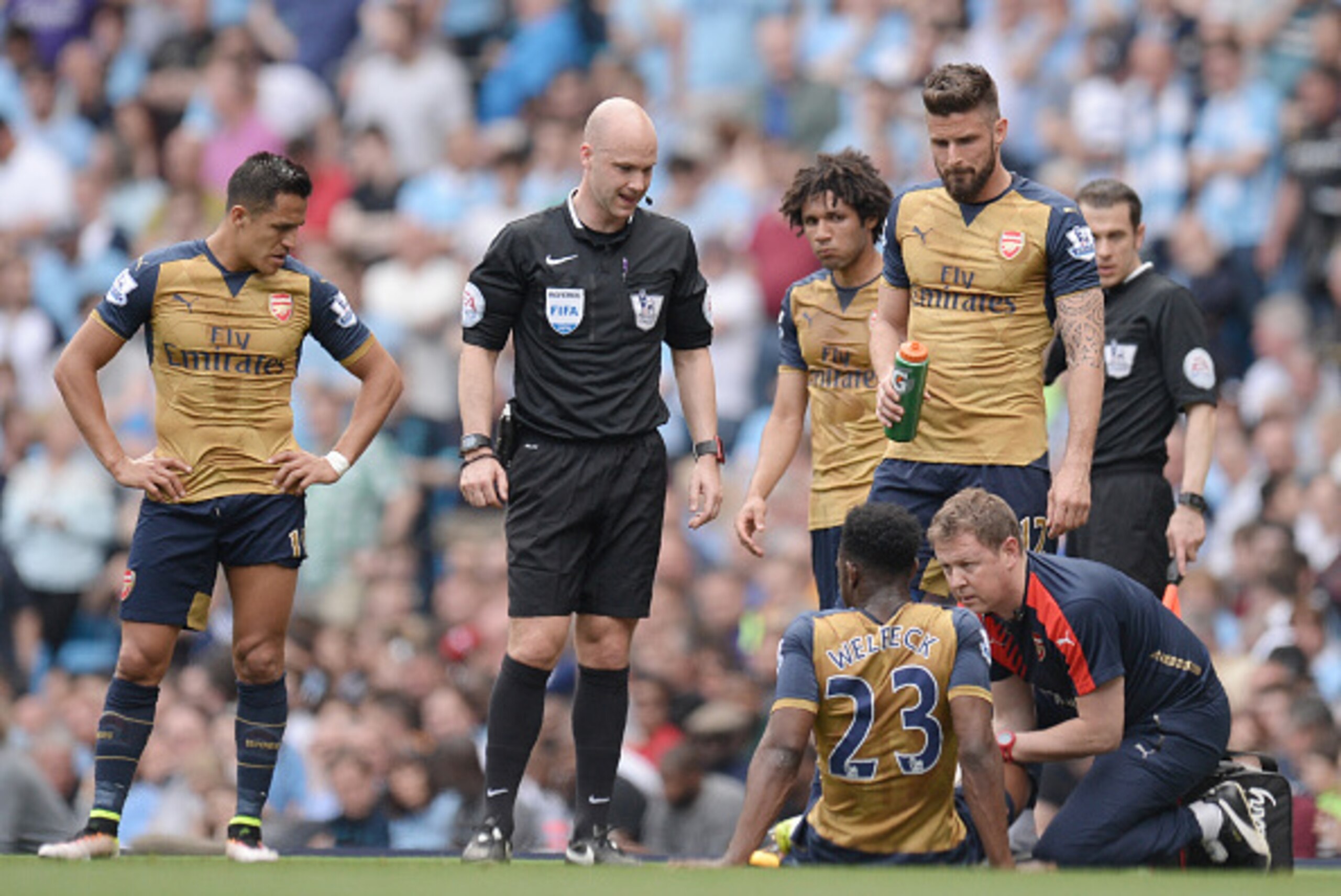 Arsenal's English striker Danny Welbeck (2R) receives medical assistance during the English Premier League football match between Manchester City and Arsenal at the Etihad Stadium in Manchester, north west England, on May 8, 2016. / AFP / OLI SCARFF / RES