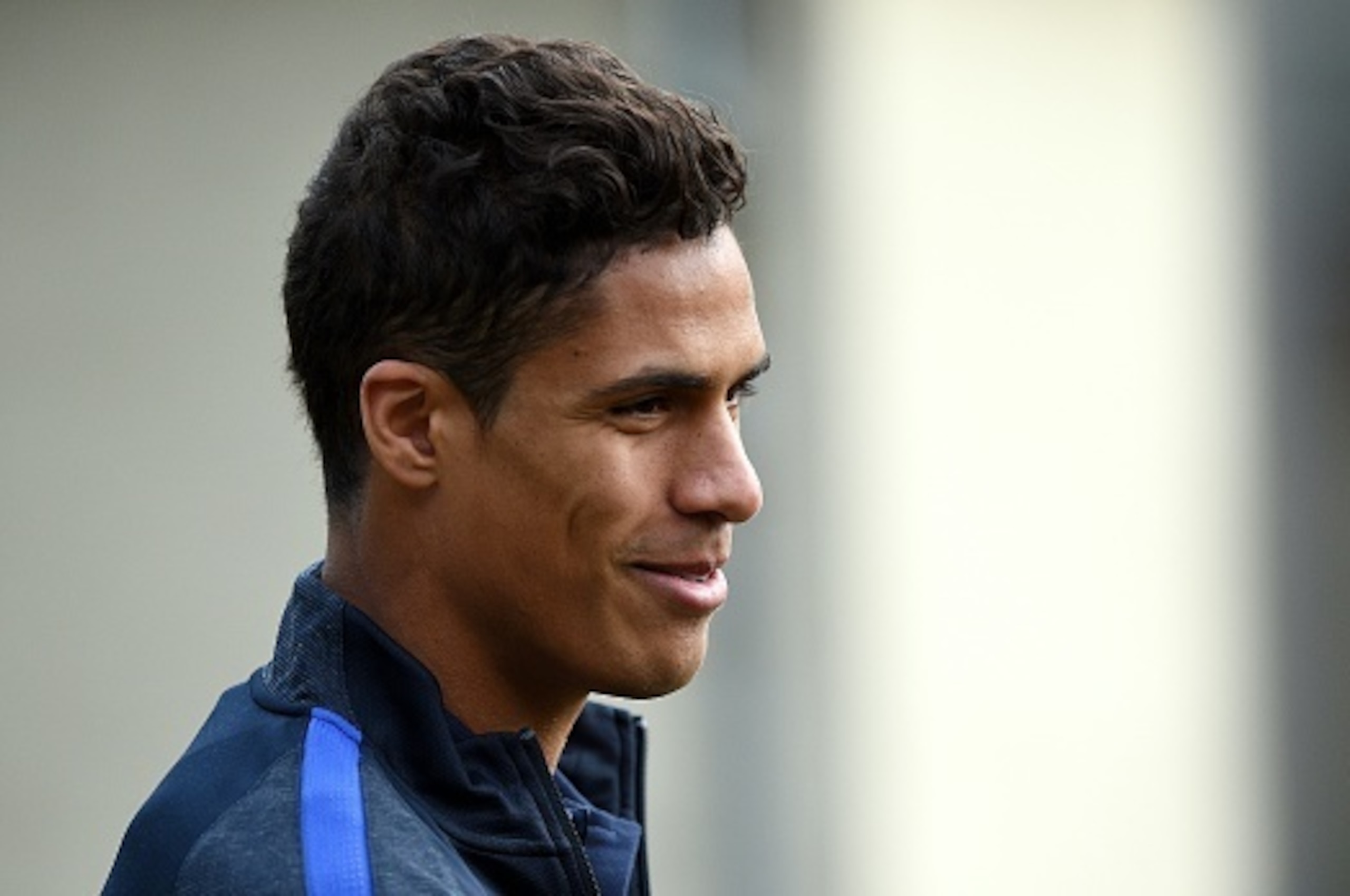 France's defender Raphael Varane arrives for a press conference in Clairefontaine on March 21, 2016 on the first day of their training ahead of the friendly football match against The Netherlands to be held on March  25.  / AFP / FRANCK FIFE        (Photo