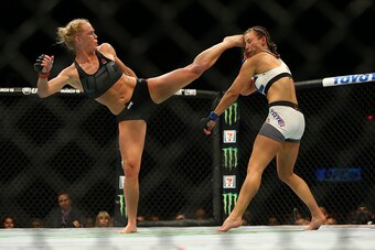LAS VEGAS, NV - MARCH 5:  UFC bantamweight champion Holly Holm (L) kicks Miesha Tate takes during UFC 196 at the MGM Grand Garden Arena on March 5, 2016 in Las Vegas, Nevada. (Photo by Rey Del Rio/Getty Images)