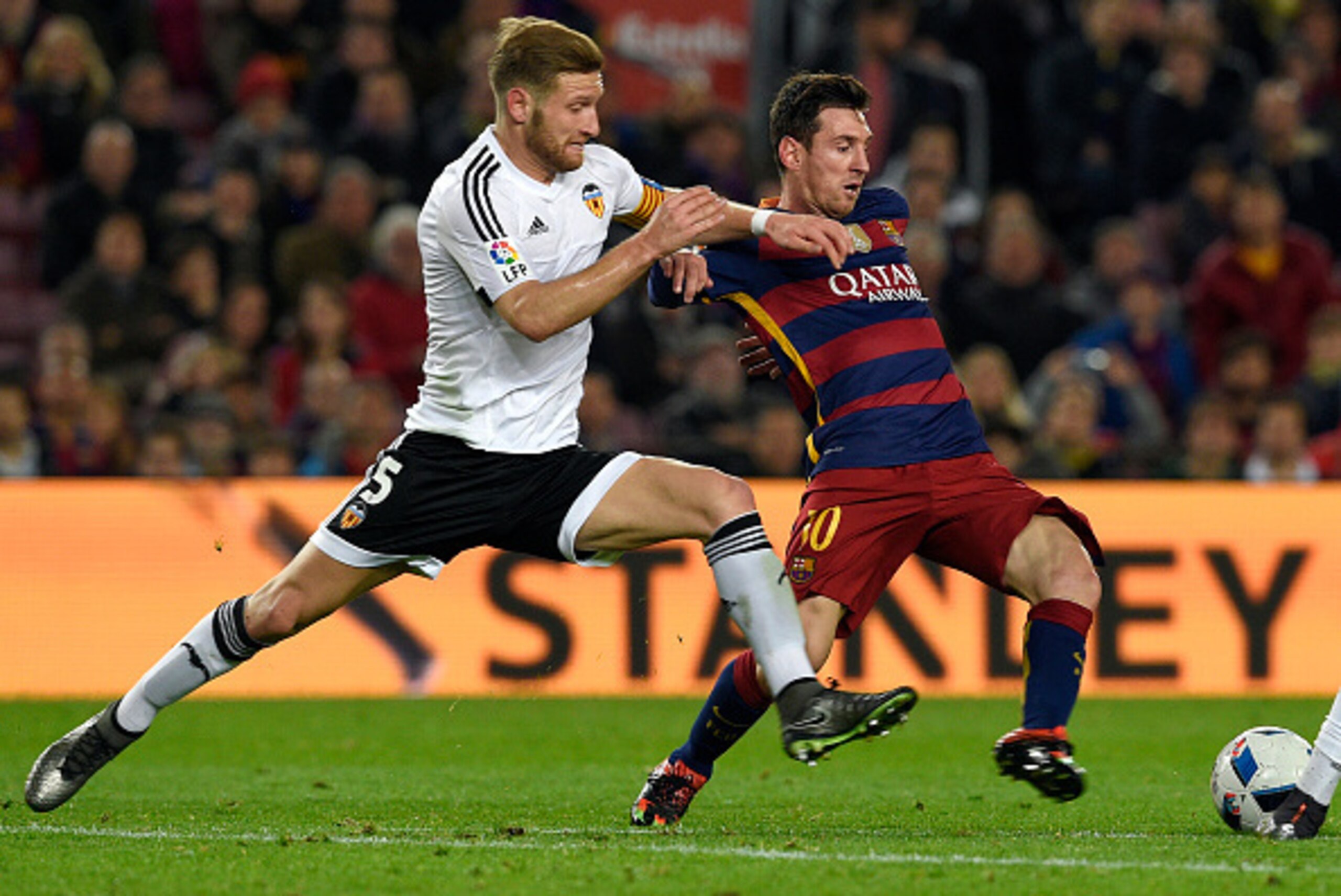 Barcelona's Argentinian forward Lionel Messi (R) vies with Valencia's German defender Shkodran Mustafi during the Spanish Copa del Rey (King's Cup) football match FC Barcelona vs Valencia CF at the Camp Nou stadium in Barcelona on February 3, 2016.   AFP 