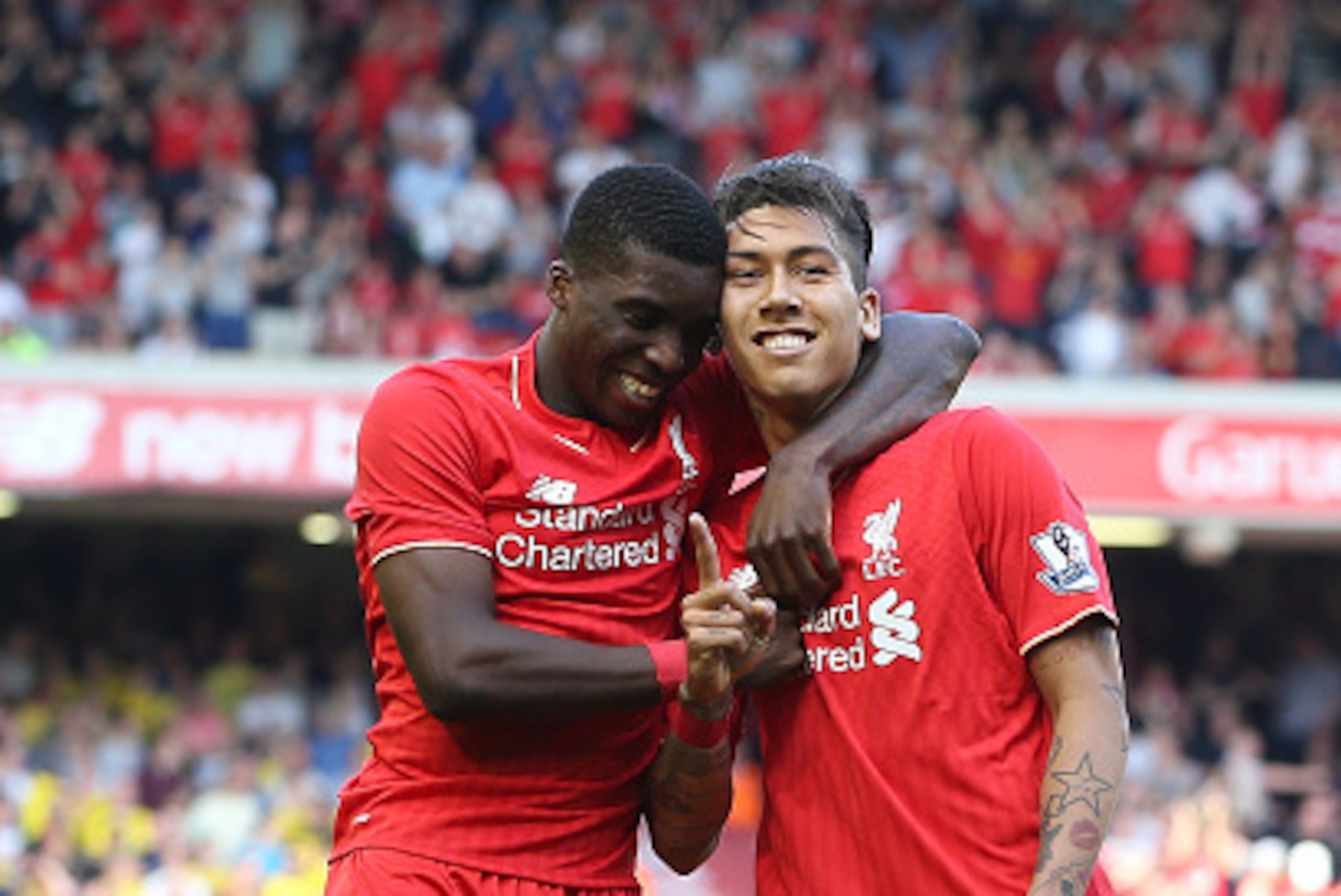 LIVERPOOL, ENGLAND - MAY 08:  Roberto Firmino of Liverpool (R) celebrates after scoring his side's second goal with Sheyi Ojo of Liverpool during the Barclays Premier League match between Liverpool and Watford at Anfield on May 8, 2016 in Liverpool, Engla