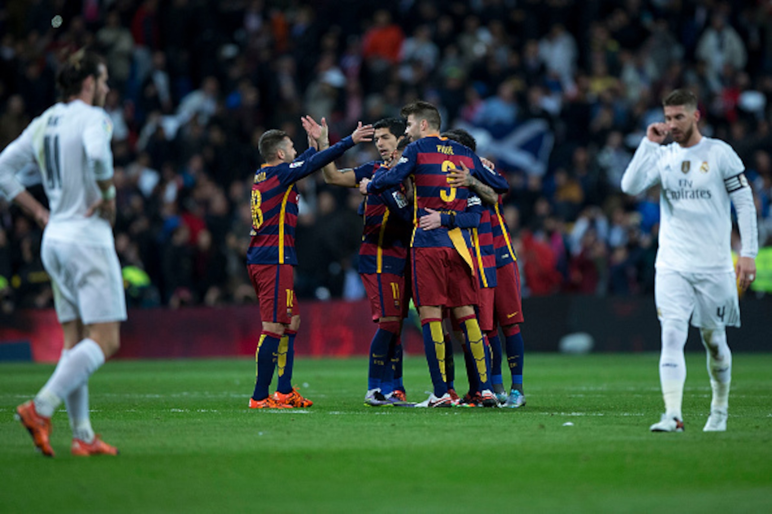 MADRID, SPAIN - NOVEMBER 21:  Luis Suarez (3dL) of FC Barcelona celebrates their victory with his teammates as Gareth Bale (L) and Sergio Ramos (R) of Real Madrid CF react defeated after the La Liga match between Real Madrid CF and FC Barcelona at Estadio