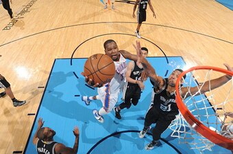 OKLAHOMA CITY, OK - MAY 8:  Kevin Durant #35 of the Oklahoma City Thunder goes to the basket against Tim Duncan #21 of the San Antonio Spurs in Game Four of the Western Conference Semifinals during the 2016 NBA Playoffs on May 8, 2016 at Chesapeake Energy