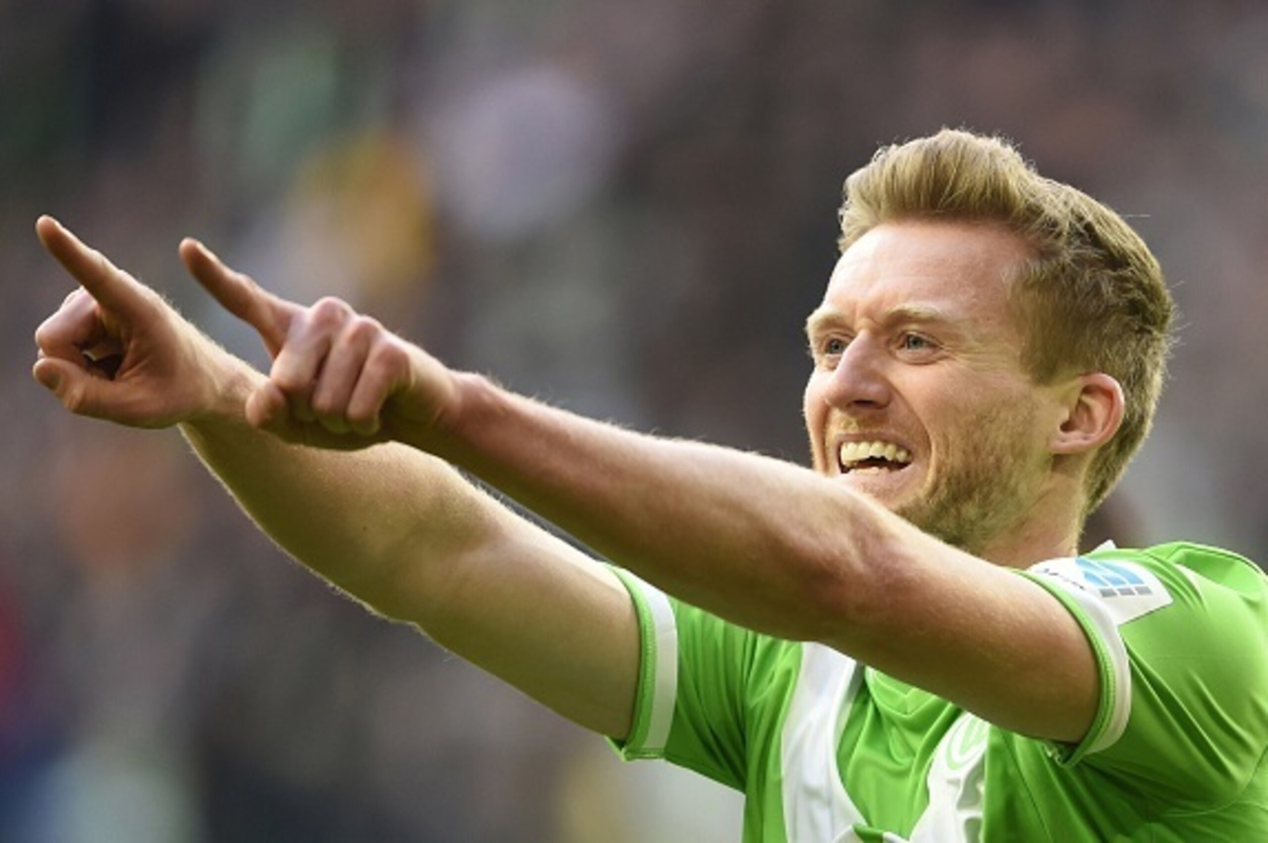 Wolfsburg's striker Andre Schuerrle celebrates after scoring his first goal for his new side during the German first division Bundesliga football match VfL Wolfsburg vs VfB Stuttgart in Wolfsburg, northern Germany, on April 4, 2015.  AFP PHOTO / TOBIAS SC