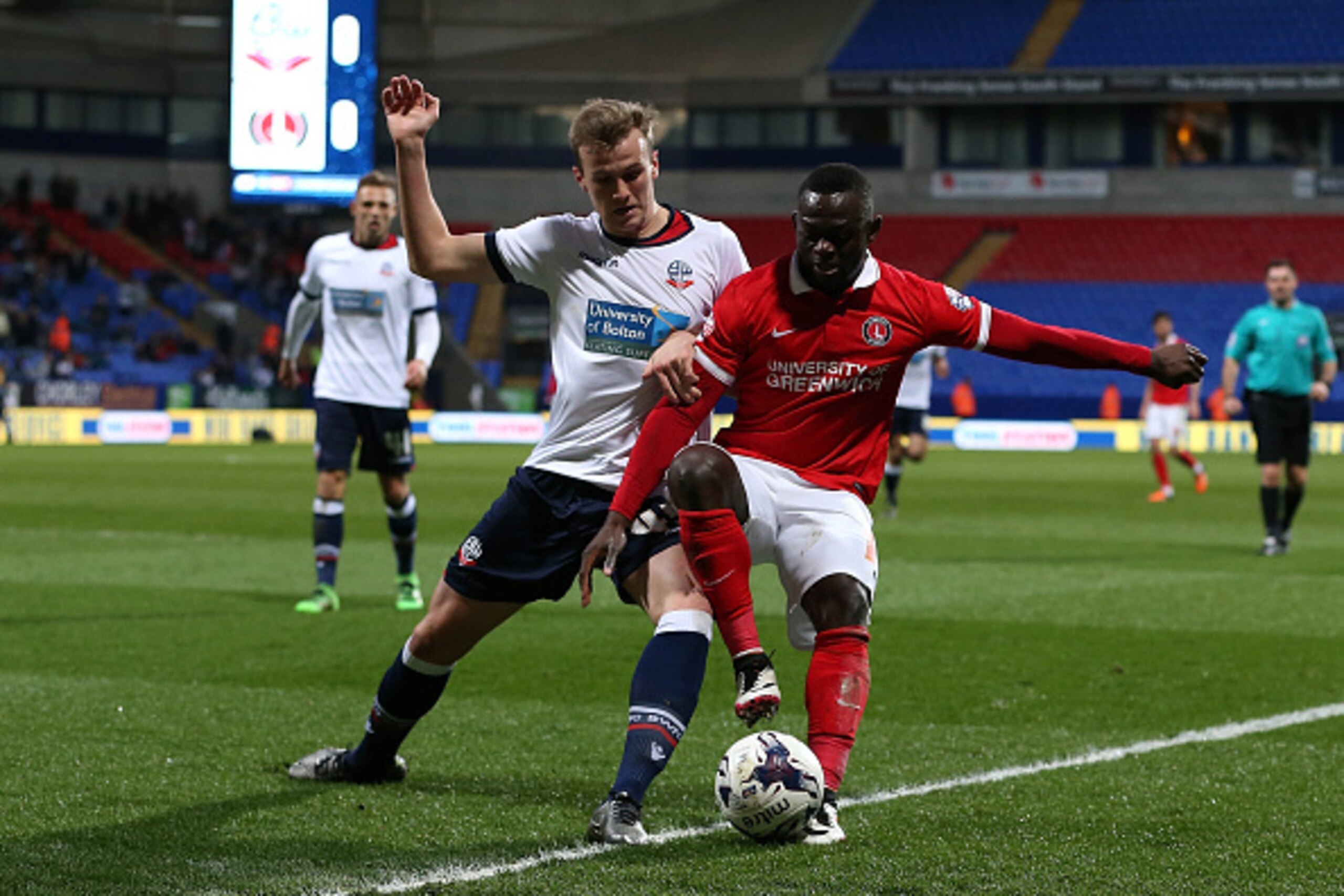 BOLTON, ENGLAND - APRIL 19:  Rob Holding of Bolton Wanderers battles with Igor Vetokele of Charlton Athletic during the Sky Bet Championship match between Bolton Wanderers and Charlton Athletic at Reebok Stadium on April 19, 2016 in Bolton, United Kingdom