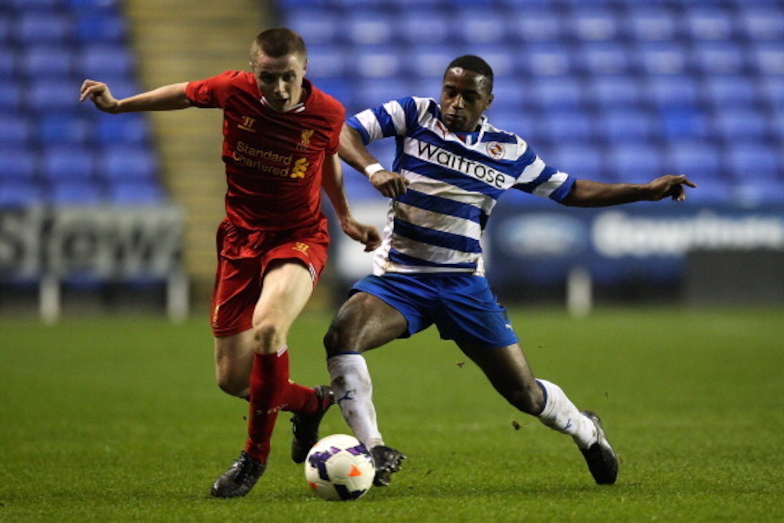 READING, ENGLAND - MARCH 12:  Jordan Rossiter of Liverpool is tackled by Tarique Fosu of Reading during the FA Youth Cup 6th Round match between Reading U18 and Liverpool U18 at Madejski Stadium on March 12, 2014 in Reading, England.  (Photo by Ben Hoskin