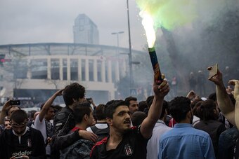 ISTANBUL, TURKEY - APRIL 11:  Besiktas fans sing and cheer on the street ahead of the opening match of the new Vodafone Arena between Besiktas and Bursaspor on April 11, 2016 in Istanbul, Turkey.  The new multi-purpose stadium has an approximate capacity 