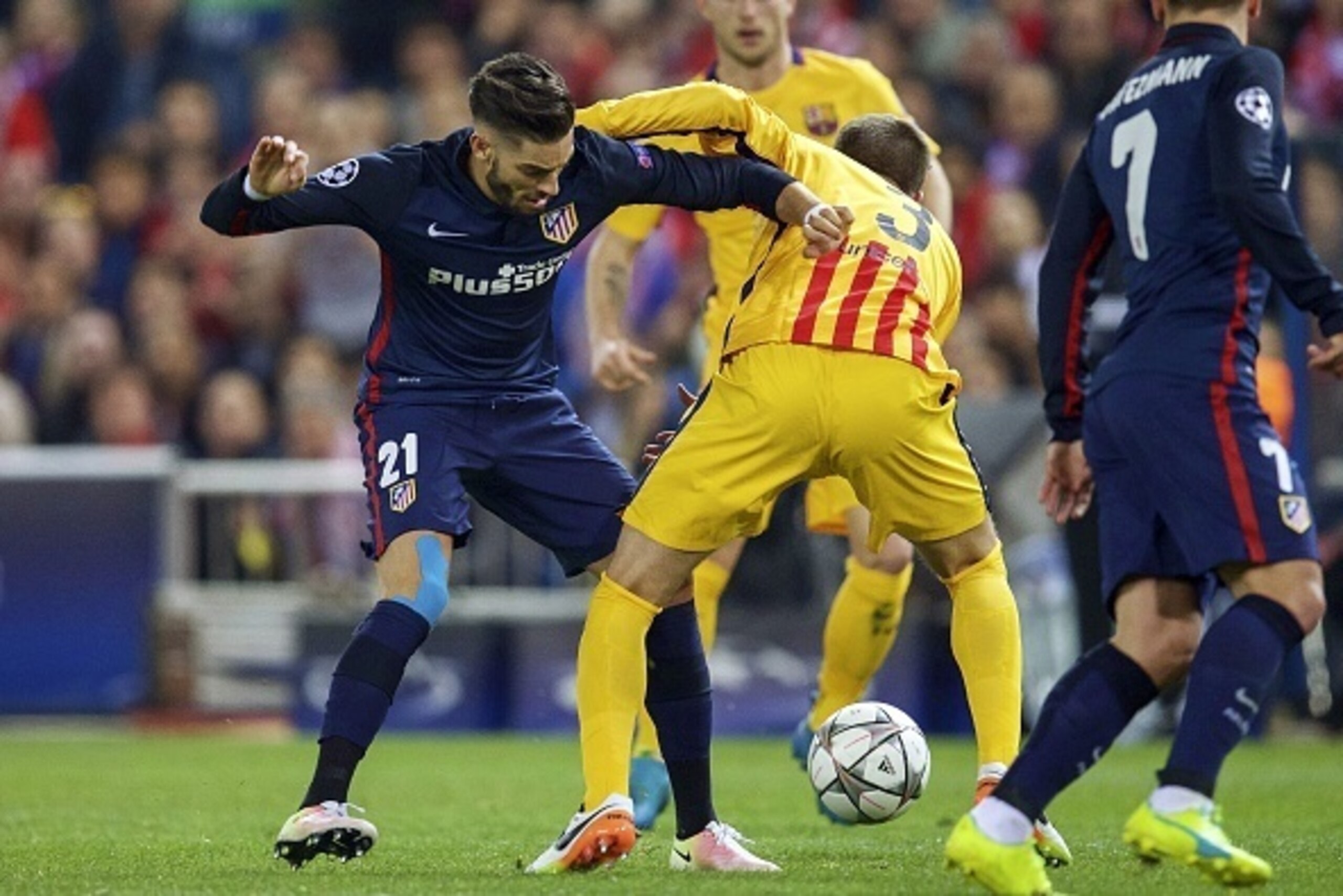 (L-R) Yannick Carrasco of Club Atletico de Madrid, Gerard Pique of FC Barcelona during the UEFA Champions League quarter-final match between  Atletico Madrid and FC Barcelona on April 13, 2016 at the Vicente Calderon stadium in Madrid, Spain.(Photo by VI 