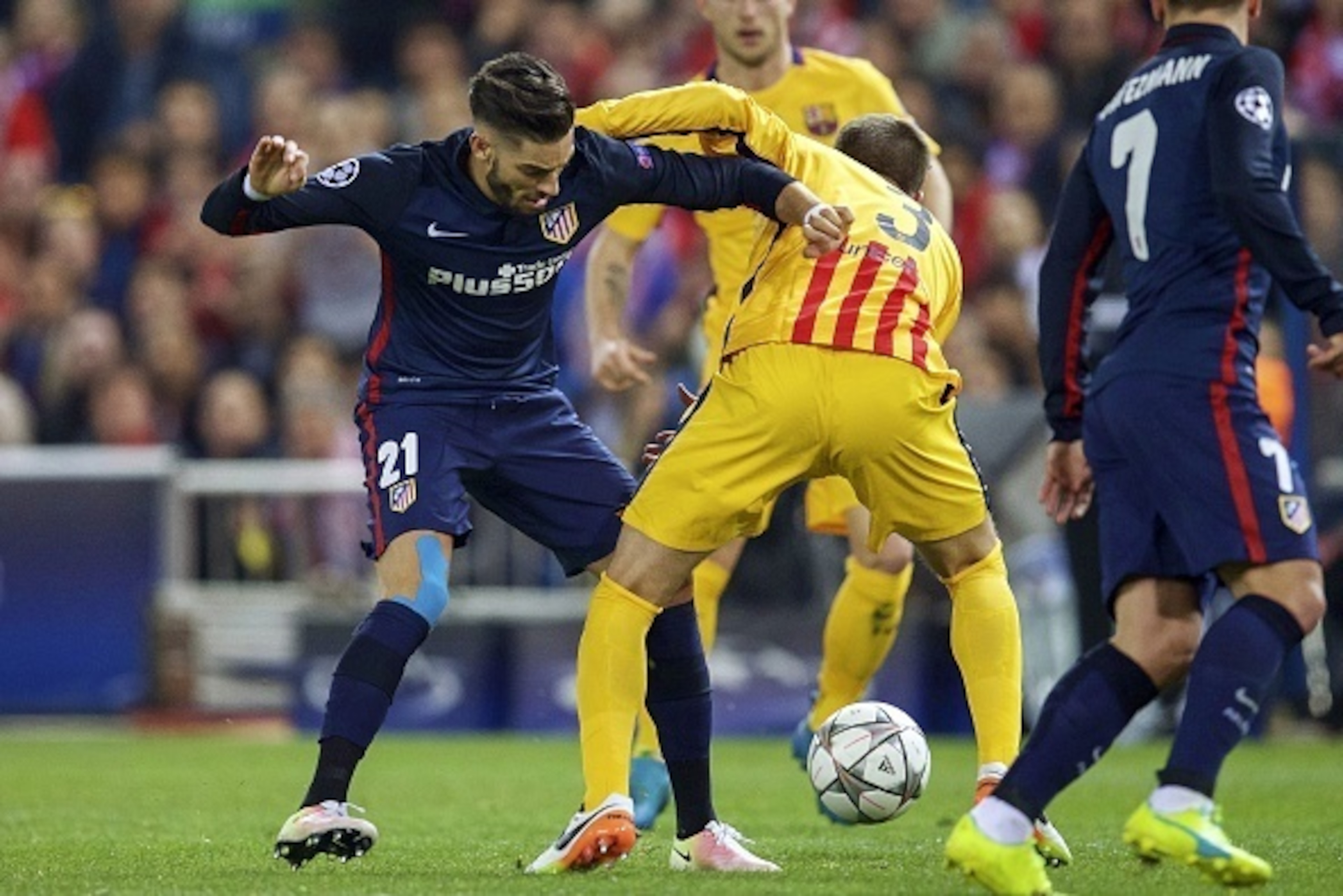 (L-R) Yannick Carrasco of Club Atletico de Madrid, Gerard Pique of FC Barcelona during the UEFA Champions League quarter-final match between  Atletico Madrid and FC Barcelona on April 13, 2016 at the Vicente Calderon stadium in Madrid, Spain.(Photo by VI 