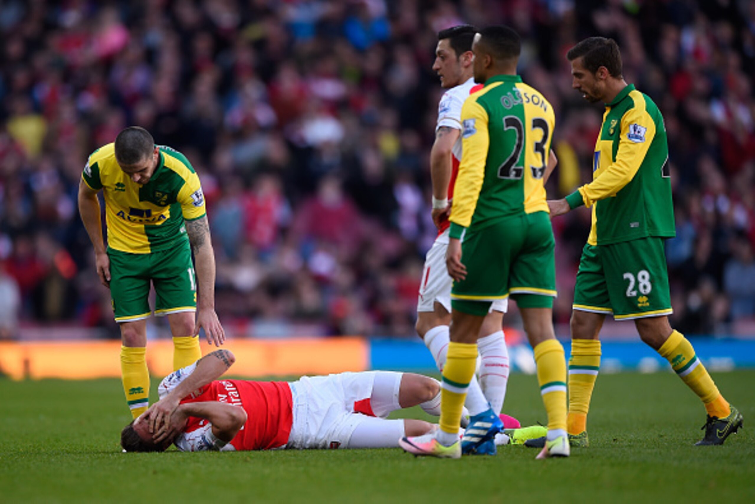 LONDON, ENGLAND - APRIL 30: Olivier Giroud of Arsenal lies on the pitch after colliding with Sebastien Bassong of Norwich City during the Barclays Premier League match between Arsenal and Norwich City at The Emirates Stadium on April 30, 2016 in London, E