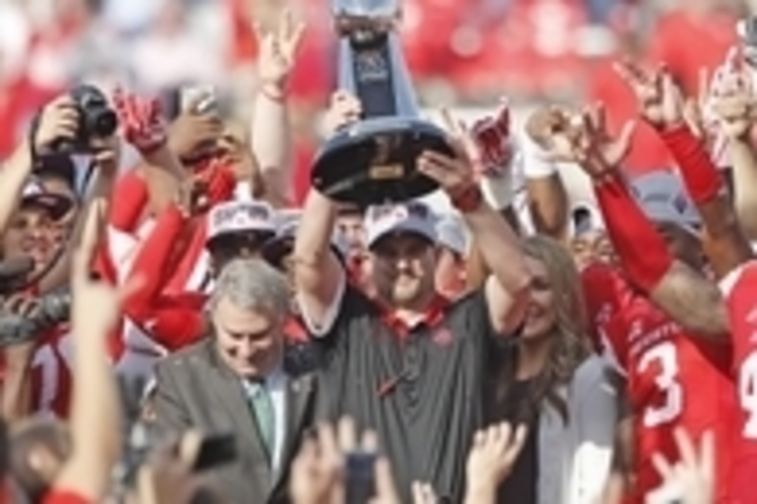 Dec 5, 2015; Houston, TX, USA; Houston Cougars head coach Tom Herman hold up the 2015 Mid-American Conference trophy after defeating the Temple Owls in the in the Mid-American Conference football championship game at TDECU Stadium. Houston won 24 to 13. M