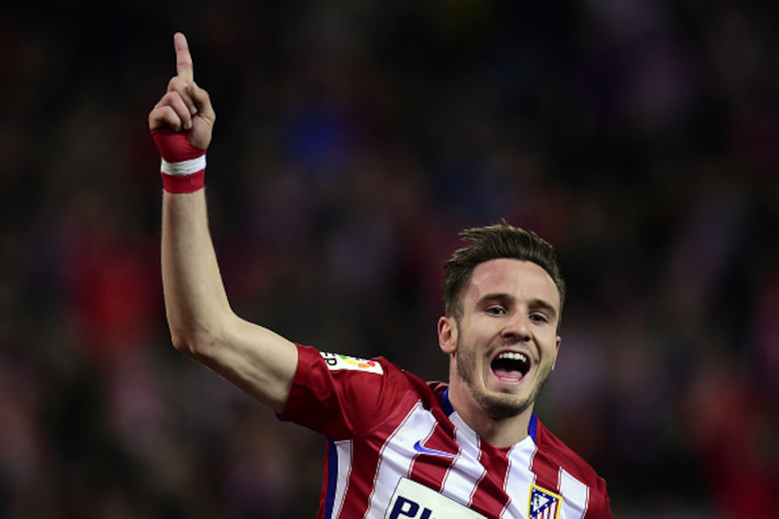Atletico Madrid's midfielder Saul Niguez celebrates after scoring during the Spanish league football match Club Atletico de Madrid vs RC Deportivo La Coruna at the Vicente Calderon stadium in Madrid on March 12, 2016. / AFP / JAVIER SORIANO        (Photo 