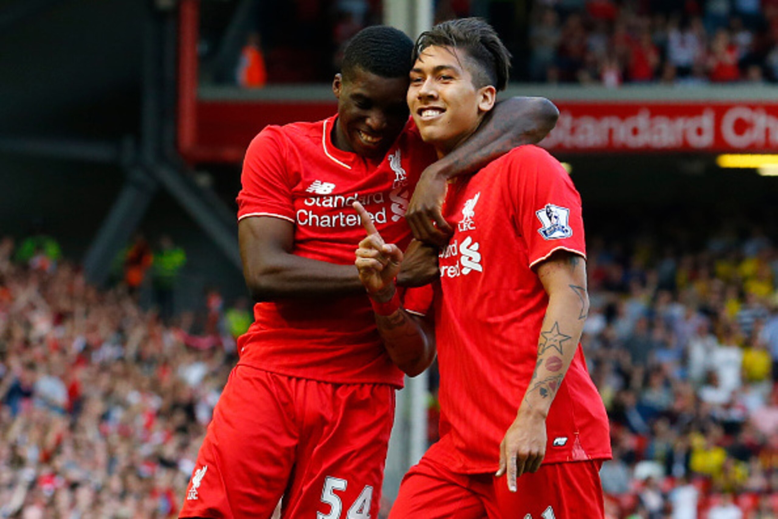 Liverpool's Brazilian midfielder Roberto Firmino (R) celebrates with Liverpool's English midfielder Oluwaseyi Ojo after scoring his team's second goal during the English Premier League football match between Liverpool and Watford at Anfield in Liverpool, 