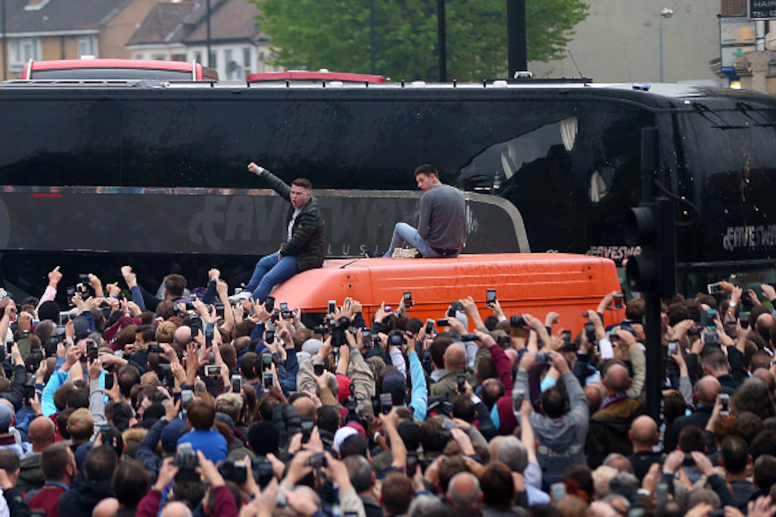LONDON, ENGLAND - MAY 10:  Damage can be seen to the Manchester United team bus as fans congregate in the street and throw bottles and cans prior to the Barclays Premier League match between West Ham United and Manchester United at the Boleyn Ground on Ma