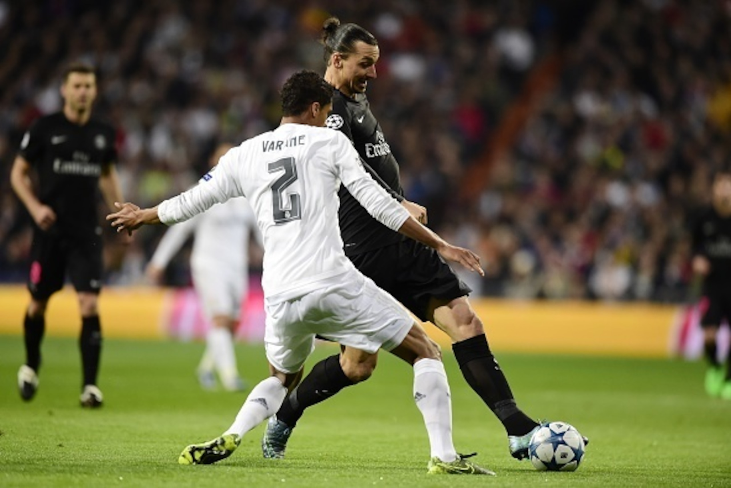 Paris Saint-Germain's Swedish forward Zlatan Ibrahimovic (R) vies with Real Madrid's French defender Raphael Varane during the UEFA Champions League football match Real Madrid CF vs Paris Saint-Germain (PSG) at the Santiago Bernabeu stadium in Madrid on N
