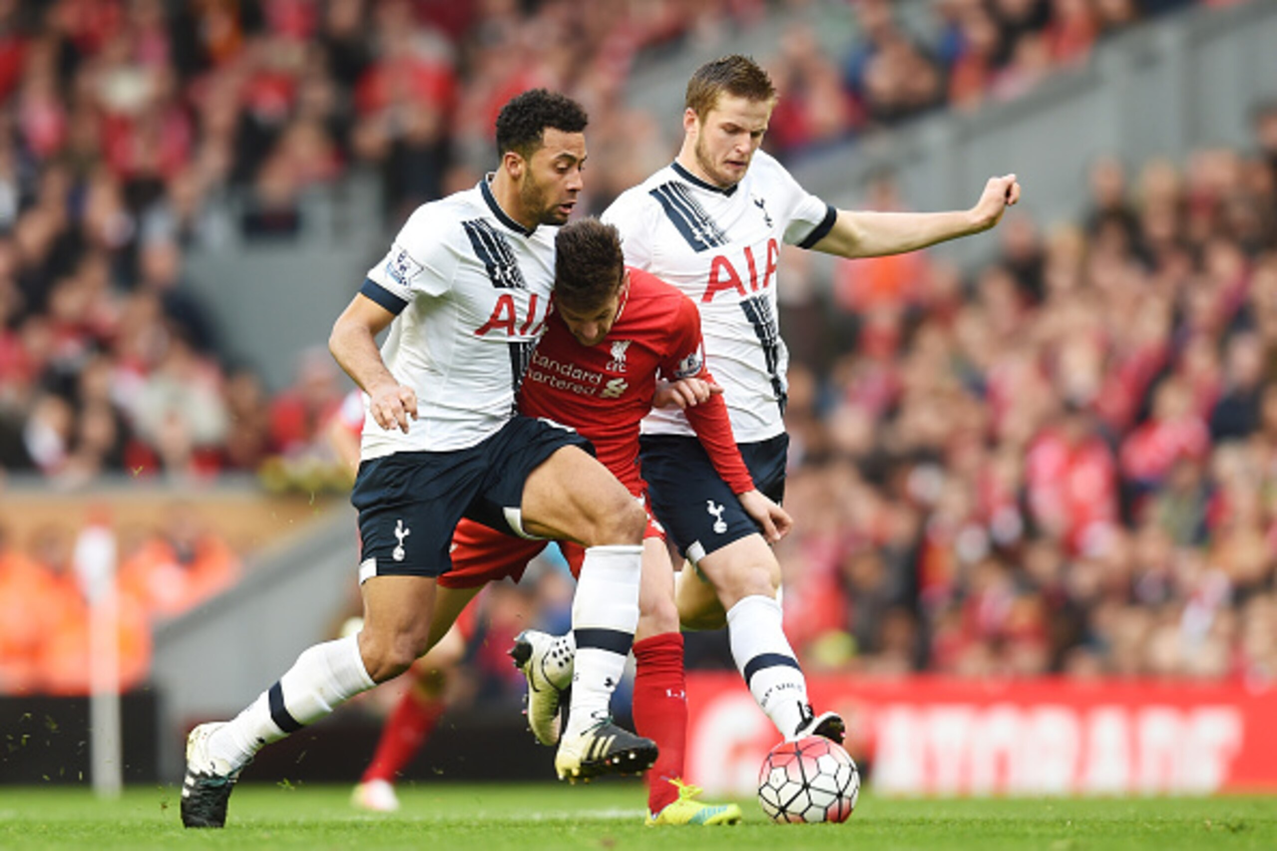 LIVERPOOL, ENGLAND - APRIL 02:  Adam Lallana (C) of Liverpool competes for the ball against Mousa Dembele (L) and Eric Dier (R) of Tottenham Hotspur  during the Barclays Premier League match between Liverpool and Tottenham Hotspur at Anfield on April 2, 2