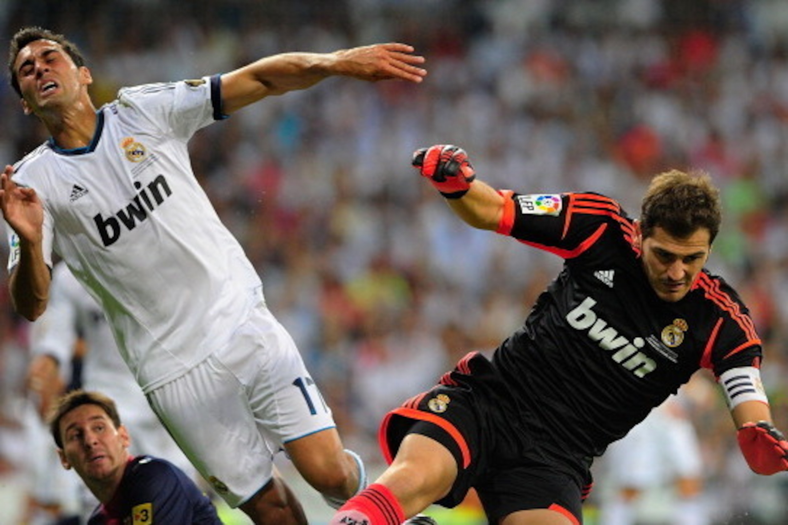 MADRID, SPAIN - AUGUST 29: Goalkeeper Iker Casillas and Alvaro Arbeloa of Real Madrid in action after stopping the ball as  Leo Messi of FC Barcelona looks on during the Supercopa second leg match between Real Madrid and Barcelona at Estadio Santiago Bern