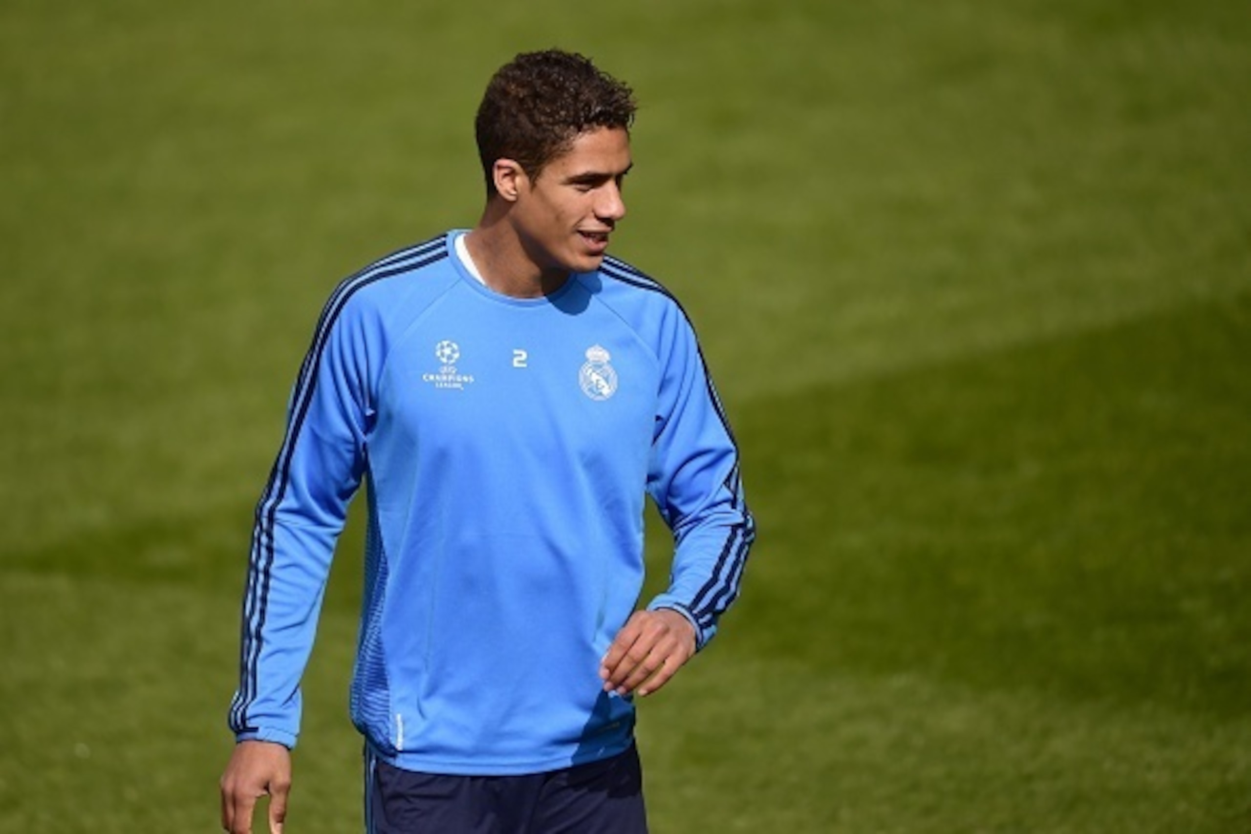 Real Madrid's French defender Raphael Varane smiles during a training session at Valdebebas Sport City in Madrid on April 11, 2016 on the eve of their Champions League second leg football match against Wolsburg.  / AFP / PIERRE-PHILIPPE MARCOU        (Pho