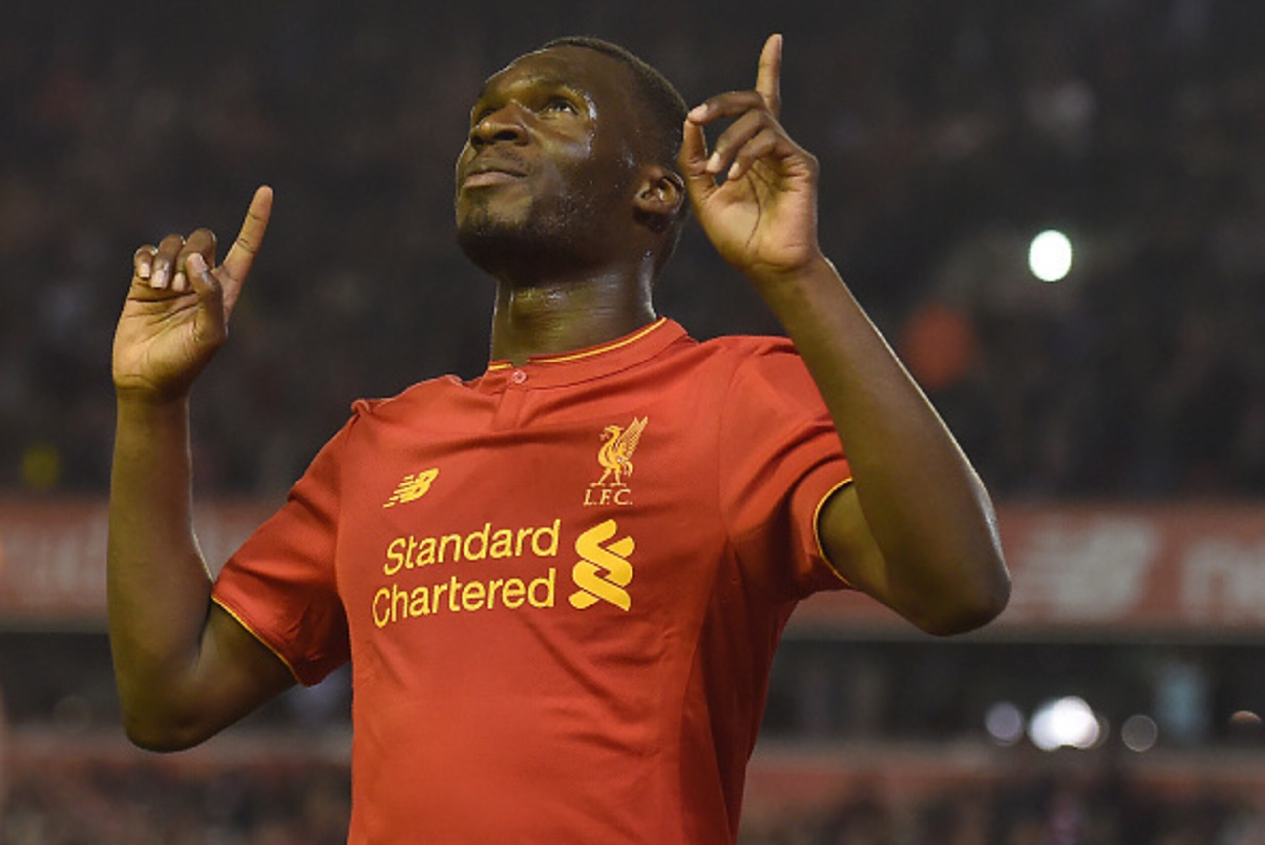 Liverpool's Christian Benteke celebrates after scoring his team's first goal during the English Premier League football match between Liverpool and Chelsea at Anfield in Liverpool, north west England on May 11, 2016. / AFP / PAUL ELLIS / RESTRICTED TO EDI