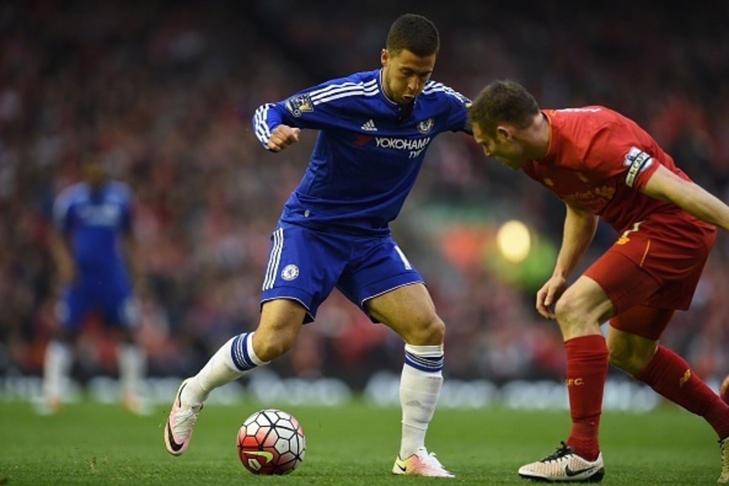 Chelsea's Belgian midfielder Eden Hazard vies with Liverpool's English midfielder James Milner during the English Premier League football match between Liverpool and Chelsea at Anfield in Liverpool, north west England on May 11, 2016. / AFP / Paul ELLIS /