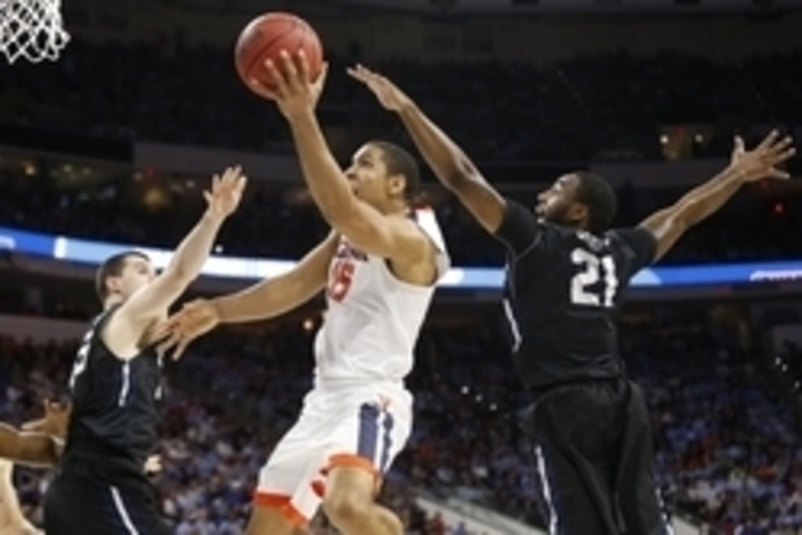 Mar 19, 2016; Raleigh, NC, USA; Virginia Cavaliers guard Malcolm Brogdon (15) shoots the ball between Butler Bulldogs forward Roosevelt Jones (21) and forward Andrew Chrabascz (45) in the second half during the second round of the 2016 NCAA Tournament at 