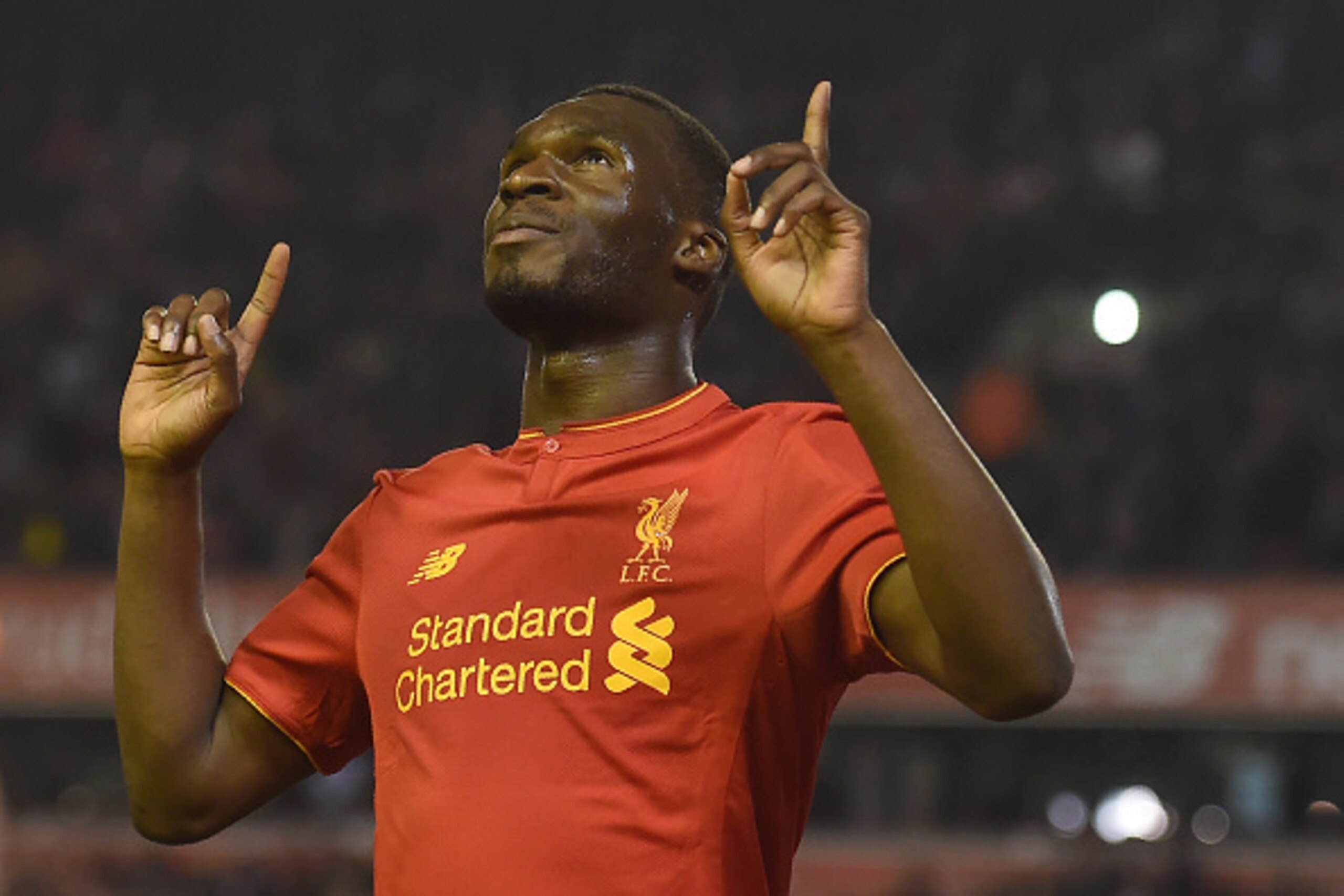 Liverpool's Christian Benteke celebrates after scoring his team's first goal during the English Premier League football match between Liverpool and Chelsea at Anfield in Liverpool, north west England on May 11, 2016. / AFP / PAUL ELLIS / RESTRICTED TO EDI