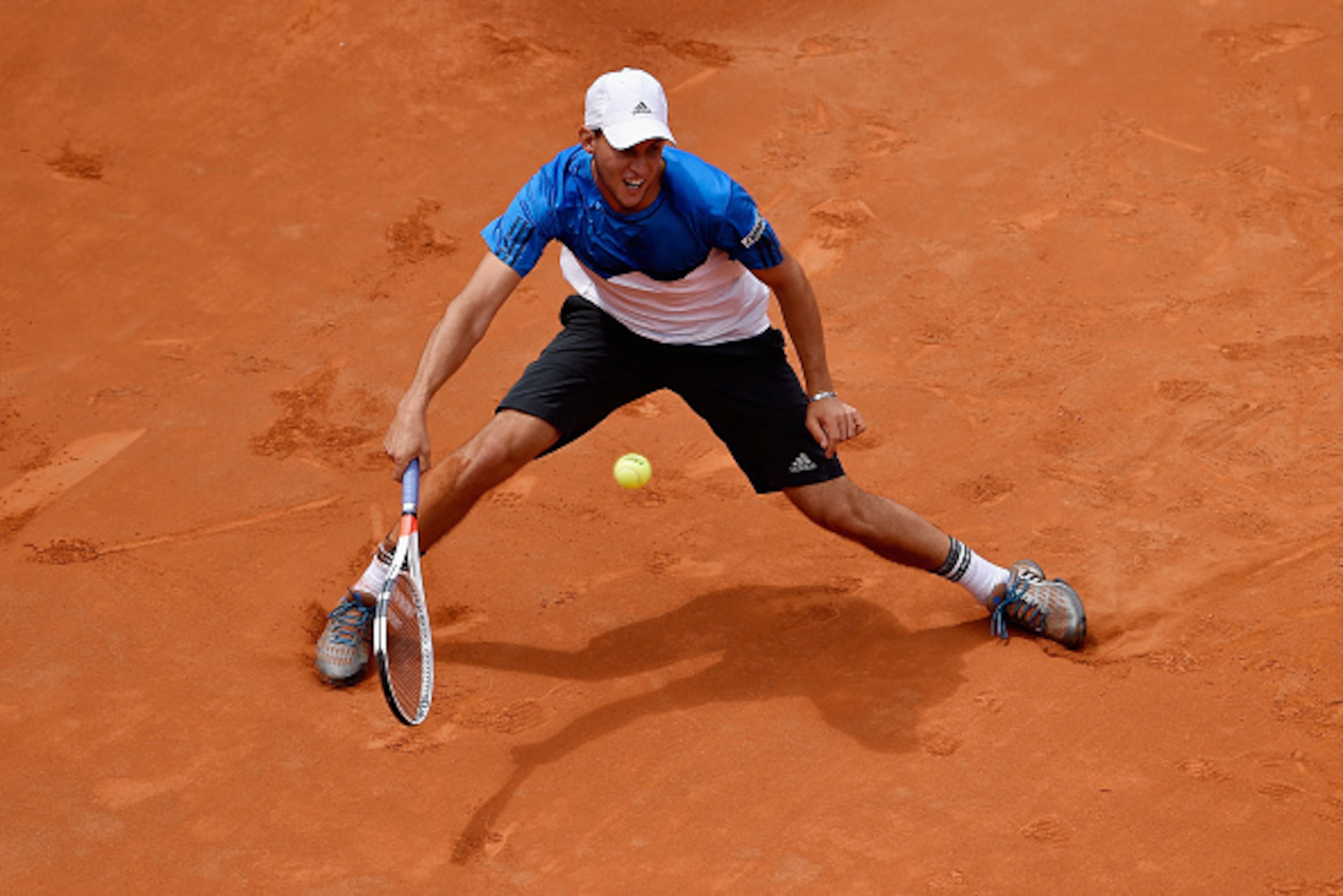 ROME, ITALY - MAY 12:  Dominic Thiem of Austria plays a forehand in his match against Roger Federer of Switzerland on Day Five of The Internazionali BNL d'Italia on May 12, 2016 in Rome, Italy.  (Photo by Dennis Grombkowski/Getty Images)