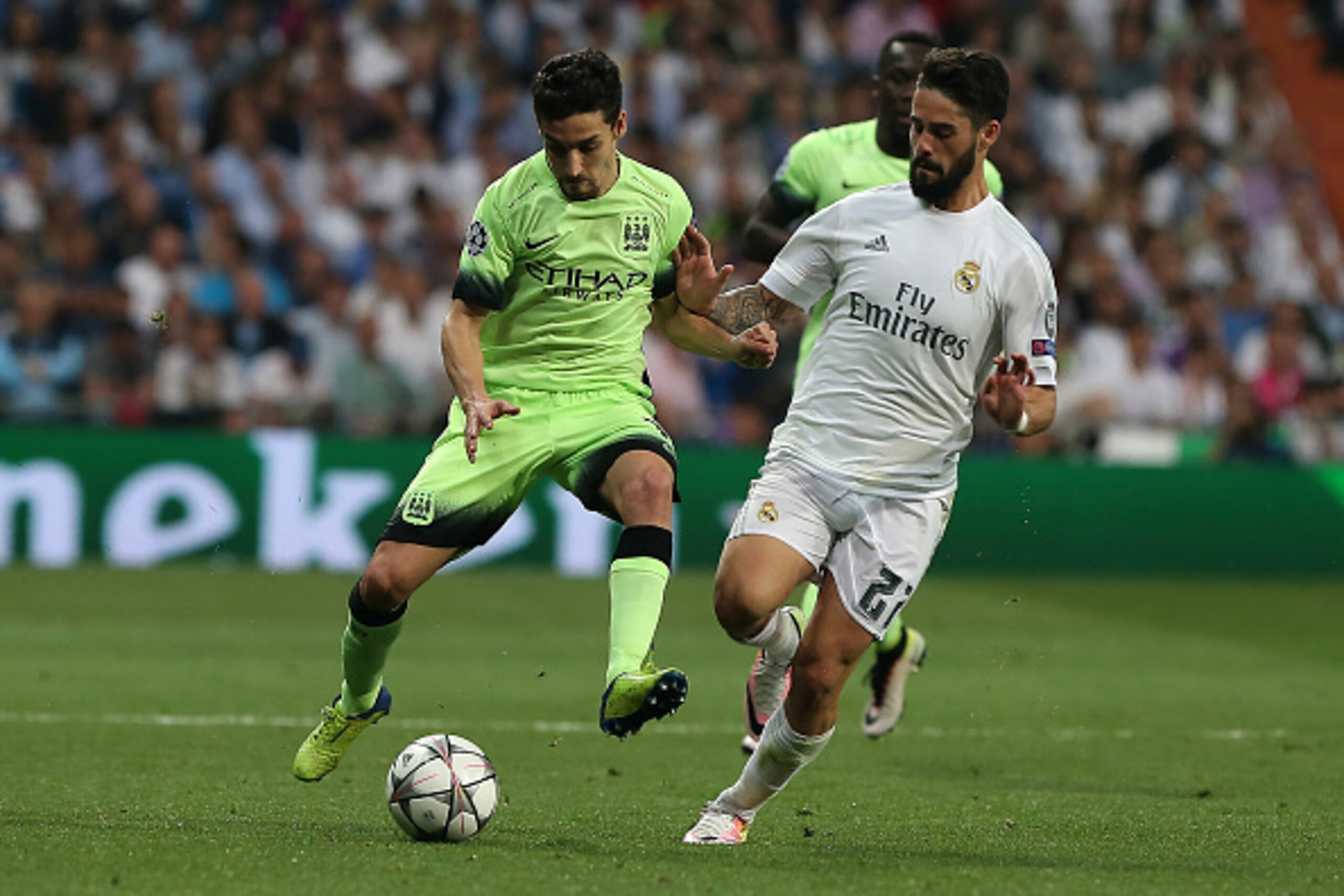 Manchester City's Spanish midfielder Jesus Navas (L) vies with Real Madrid's midfielder Isco during the UEFA Champions League semi-final second leg football match Real Madrid CF vs Manchester City FC at the Santiago Bernabeu stadium in Madrid, on May 4, 2