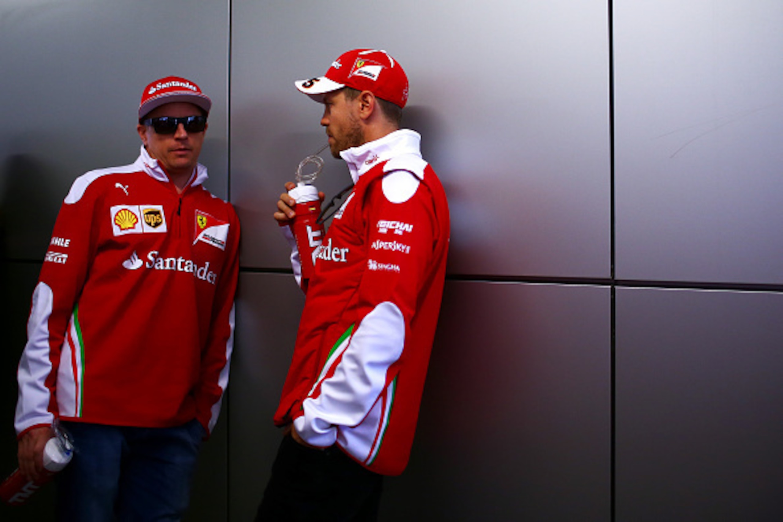 SOCHI, RUSSIA - MAY 01: Sebastian Vettel of Germany and Ferrari and Kimi Raikkonen of Finland and Ferrari talk while waiting for the drivers parade ahead of the Formula One Grand Prix of Russia at Sochi Autodrom on May 1, 2016 in Sochi, Russia.  (Photo by